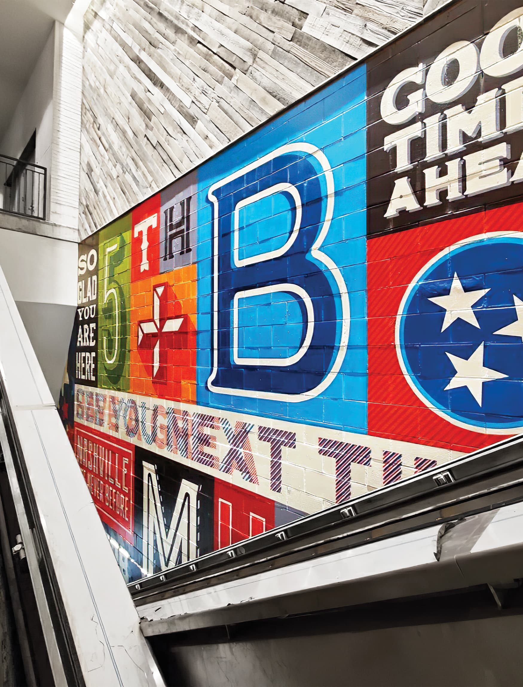 Placemaking large painted mural color blocks with brand expression of Fifth + Broadway by the escalators. Signage and wayfinding for Fifth + Broadway in Nashville, Tennessee by RSM Design