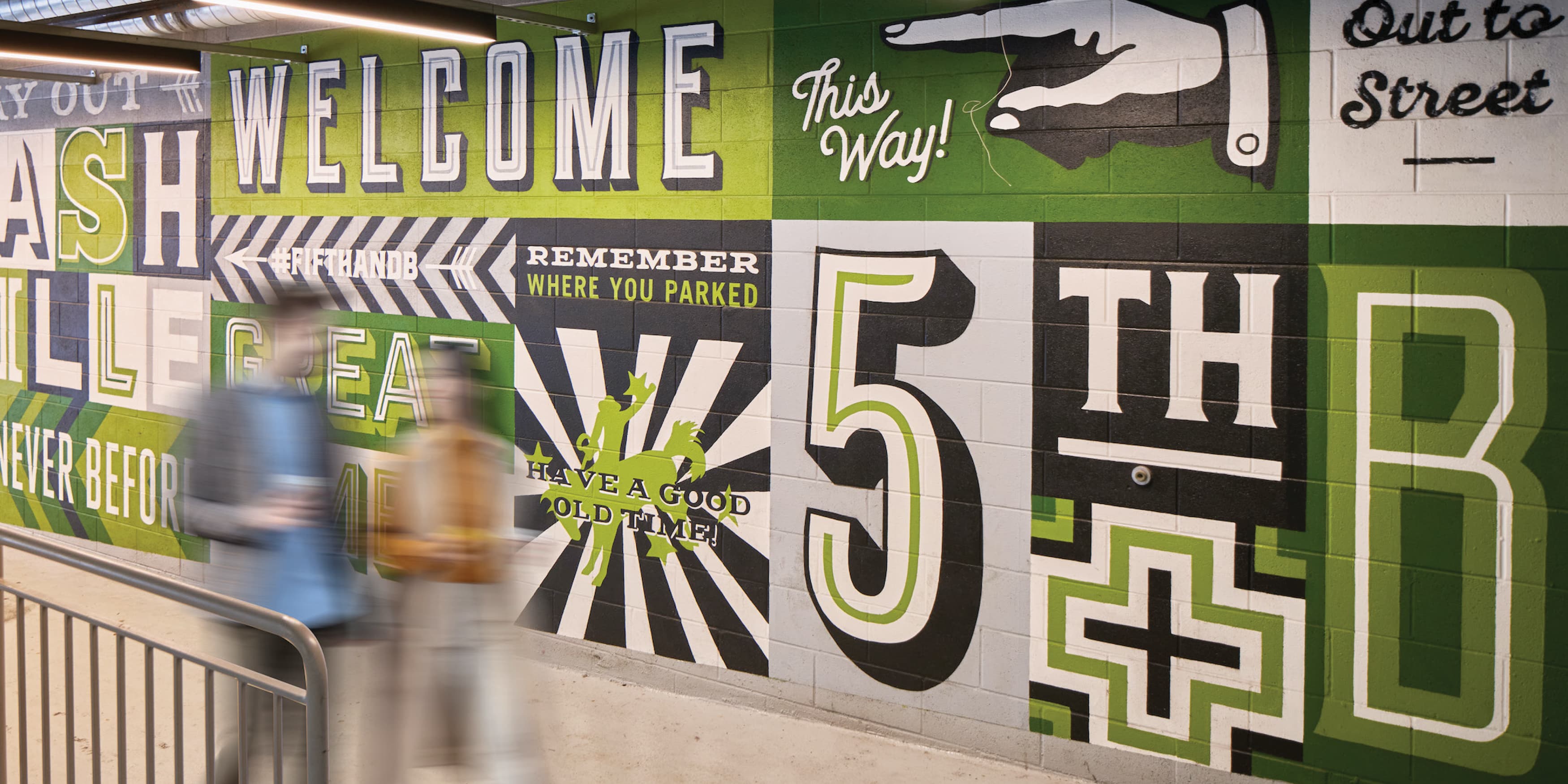 Green typography mural at Fifth + Broadway in Nashville, Tennessee. 