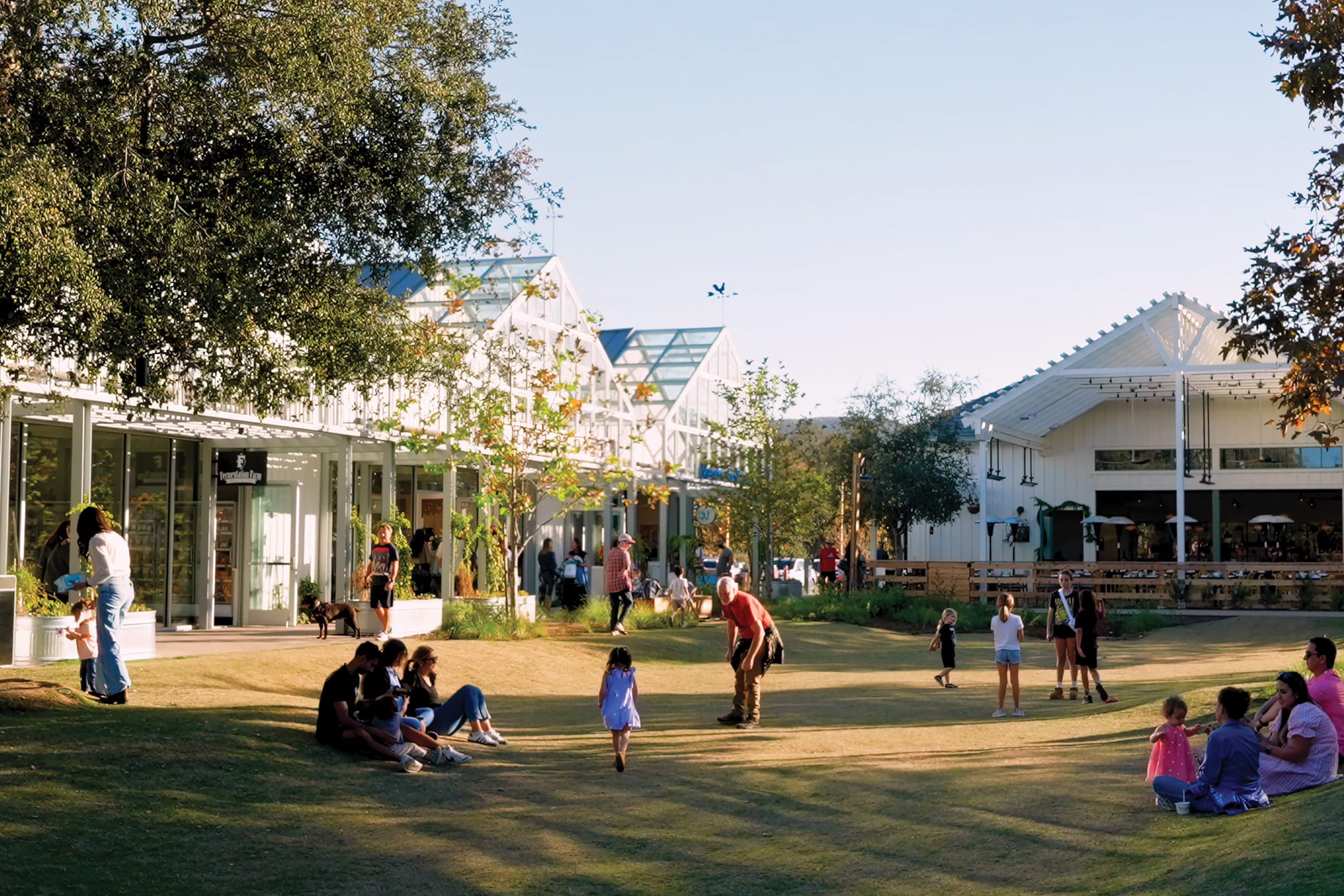 River Street Marketplace central lawn with families gathering near retail storefronts, placemaking by RSM Design