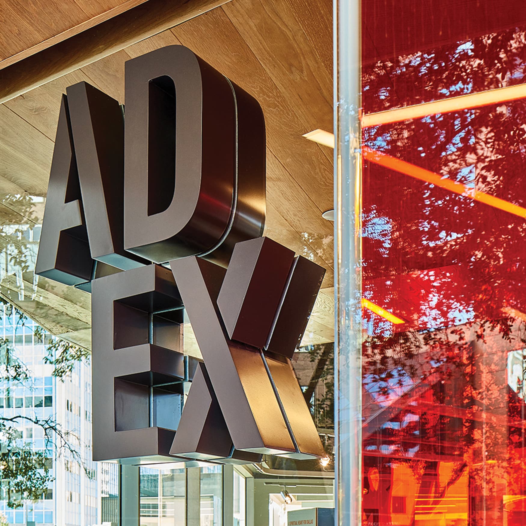 AD EX dimensional signage identity mounted to glass facade of architecture