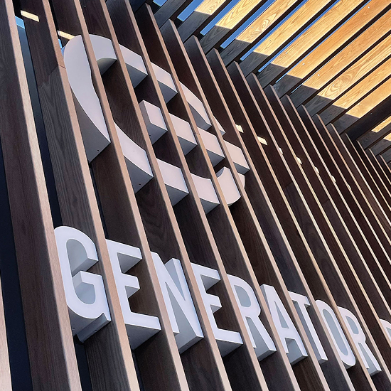 Close-up of dimensional letter Generator Bar logo signage mounted on wood slat facade, exterior environmental branding detail at San Carlos by RSM Design