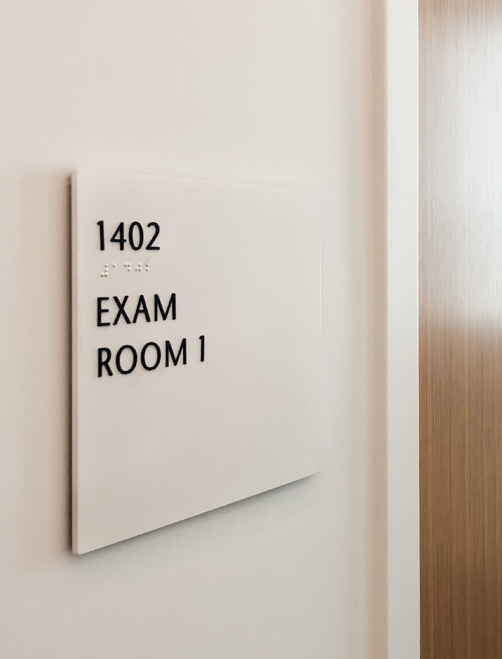 Close up image of the room identity signage at UCLA Rosenfeld Hall. 