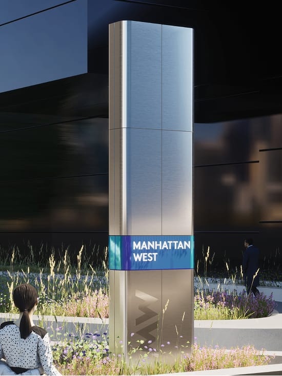 Illuminated "Manhattan West" pylon sign with "MW" logo set among landscaped grasses and wildflowers - environmental graphic design by RSM Design