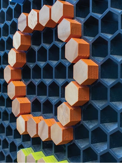 Persea residential community hexagonal peg letter sign detail in orange, environmental graphic design by RSM Design