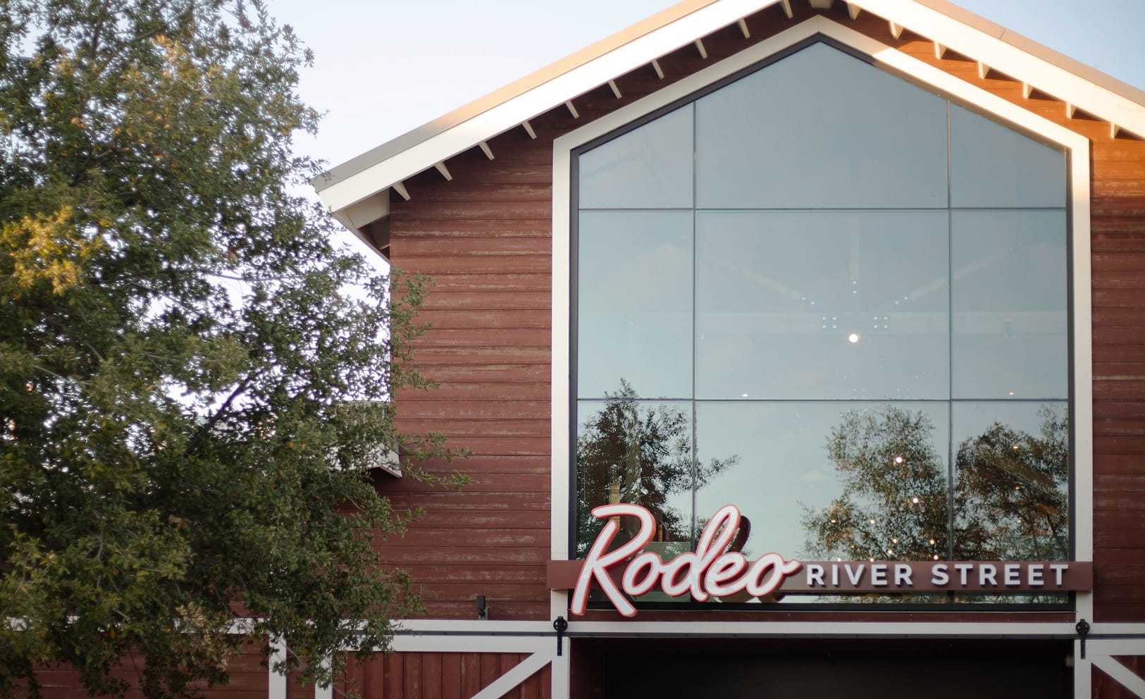 River Street Marketplace Rodeo River Street barn facade with neon signage, environmental graphic design by RSM Design