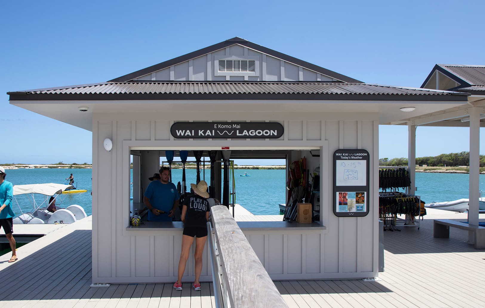 Wai Kai Lagoon rental kiosk with "E Komo Mai" oval sign overlooking the water at Ewa Beach, Oahu, environmental graphic design by RSM Design.