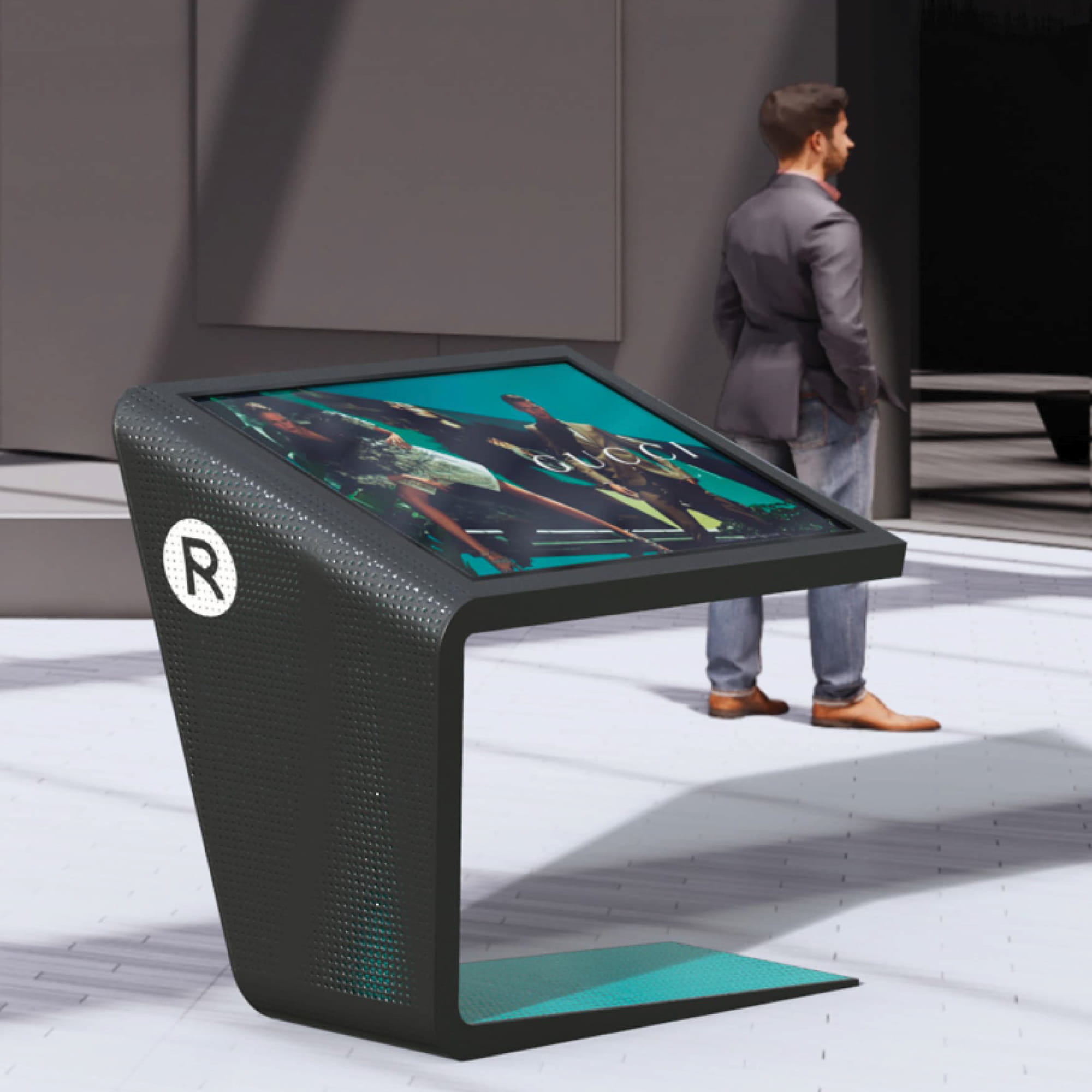 A rendering of a sleek Royalmount branded interactive digital kiosk featuring a angled touchscreen display showing a Gucci campaign, a perforated dark charcoal enclosure with a teal base accent and the Royalmount "R" logomark, positioned in a contemporary retail concourse with a pedestrian in the background — showcasing RSM Design's digital integration and interactive solutions and wayfinding and signage design services applied within the mixed-use, retail, and international markets