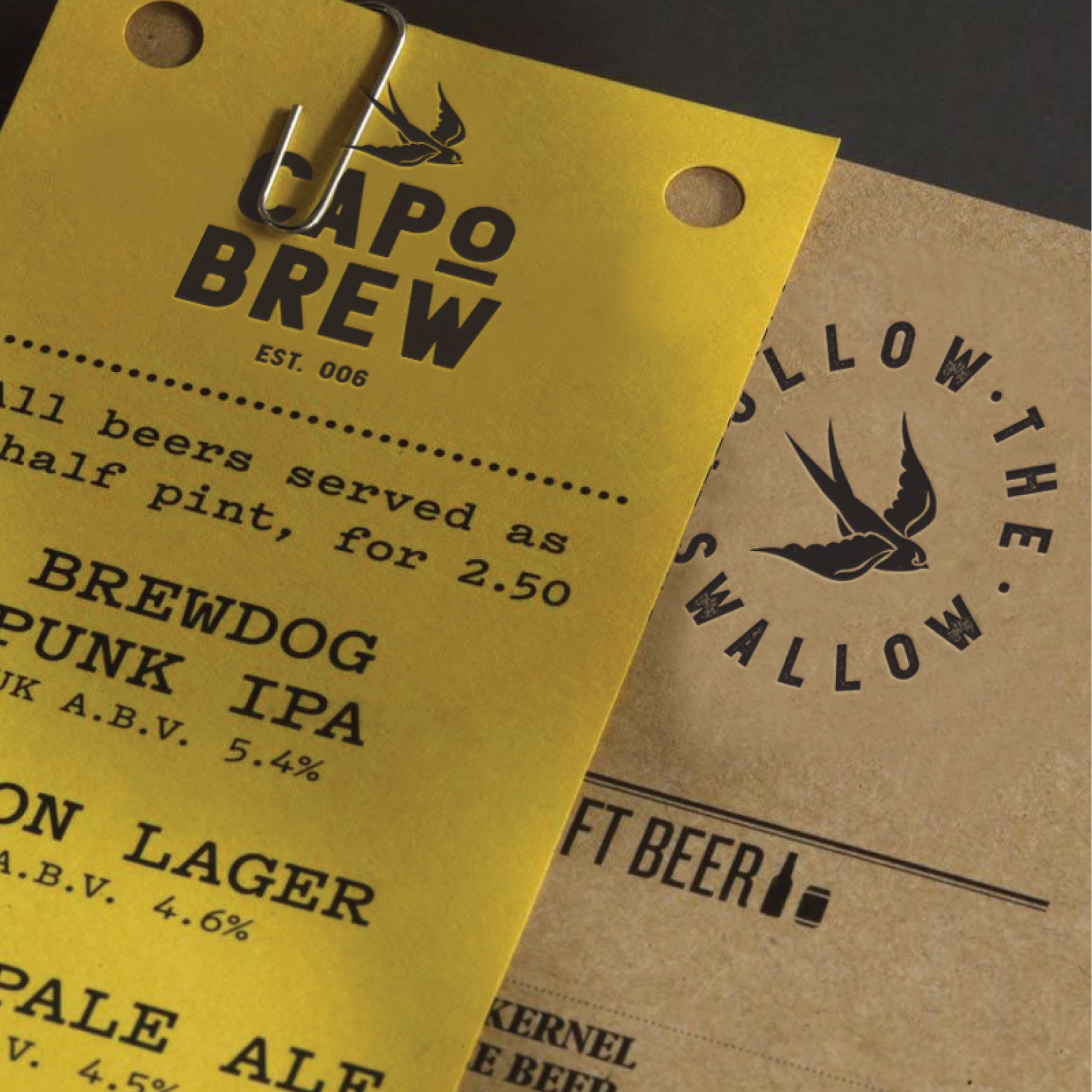 Yellow and kraft paper beer menus for Capo Brew featuring the swallow logo and "Follow the Swallow" tagline, brand identity design by RSM Design