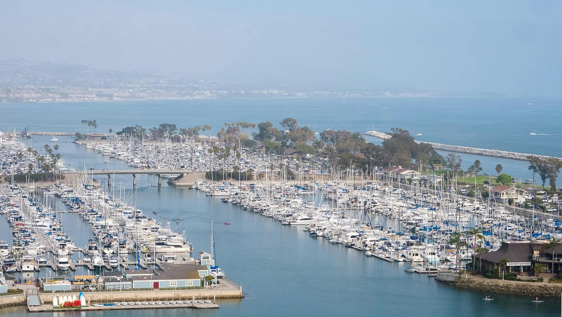 Aerial view of Dana Point Harbor with marina, boat slips, and coastline — wayfinding and environmental graphic design by RSM DesignAerial view of Dana Point Harbor with marina, boat slips, and coastline — wayfinding and environmental graphic design by RSM Design