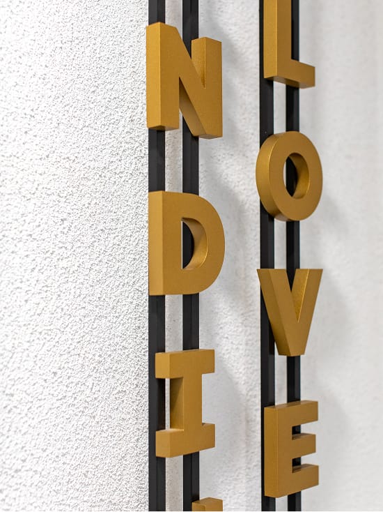 Persea residential community vertical dimensional letter signage detail in gold, environmental graphic design by RSM Design