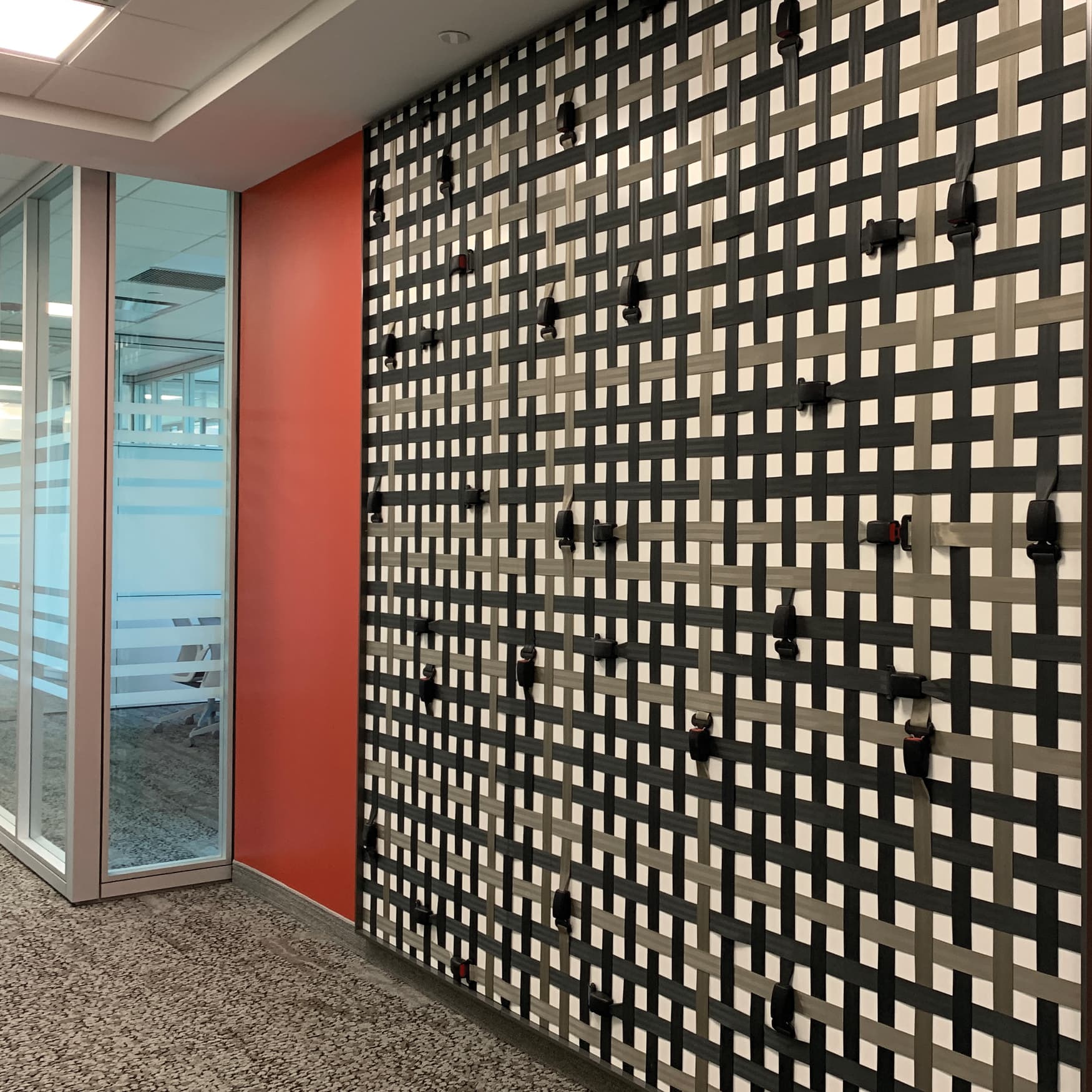 Speciality art mural by RSM Design for JMFE Headquarters consisting of seatbelts in a grid pattern for office workplace design. Seatbelt art. 