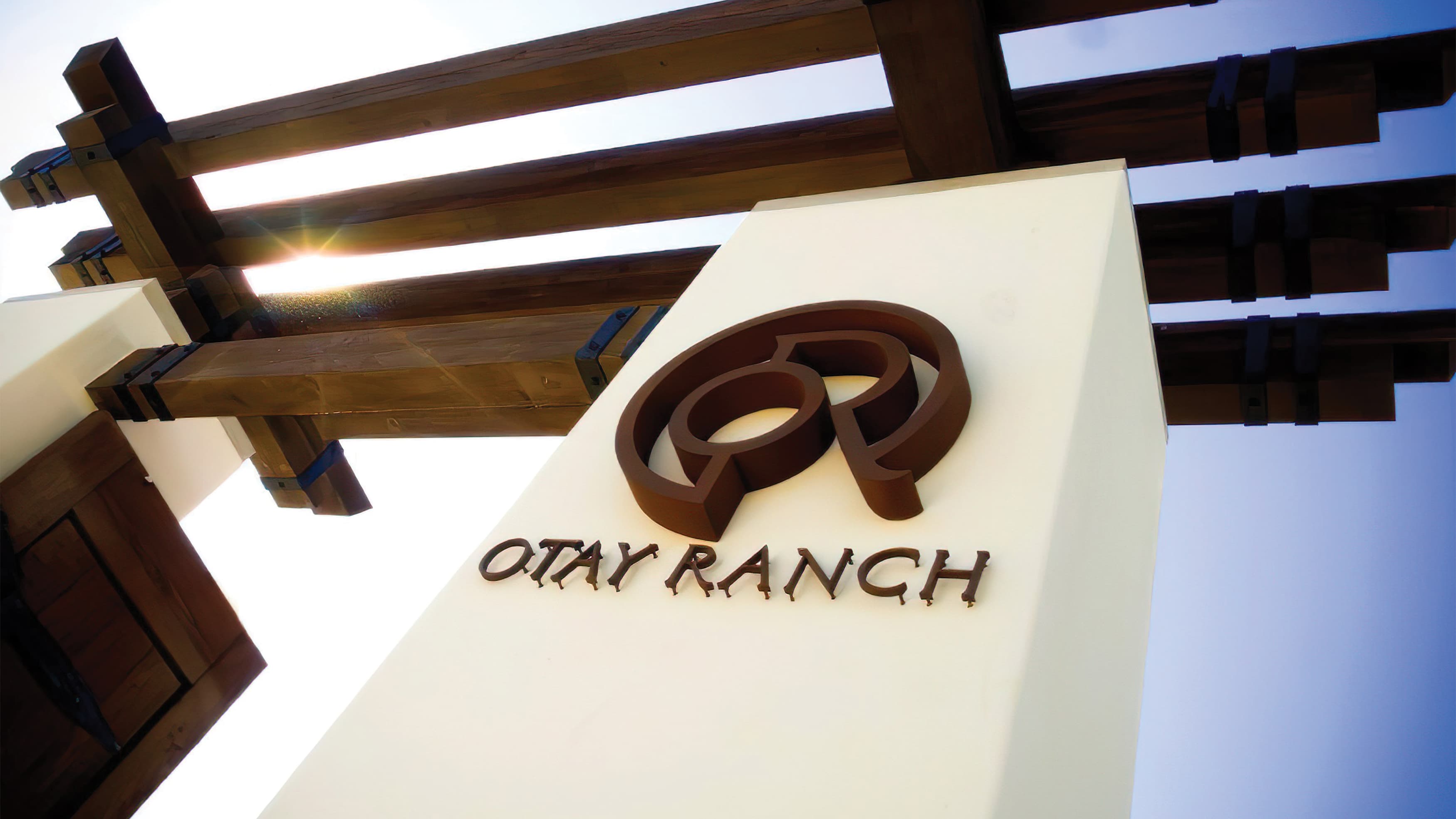 Otay Ranch corten metal identity fastened to Spanish-style column