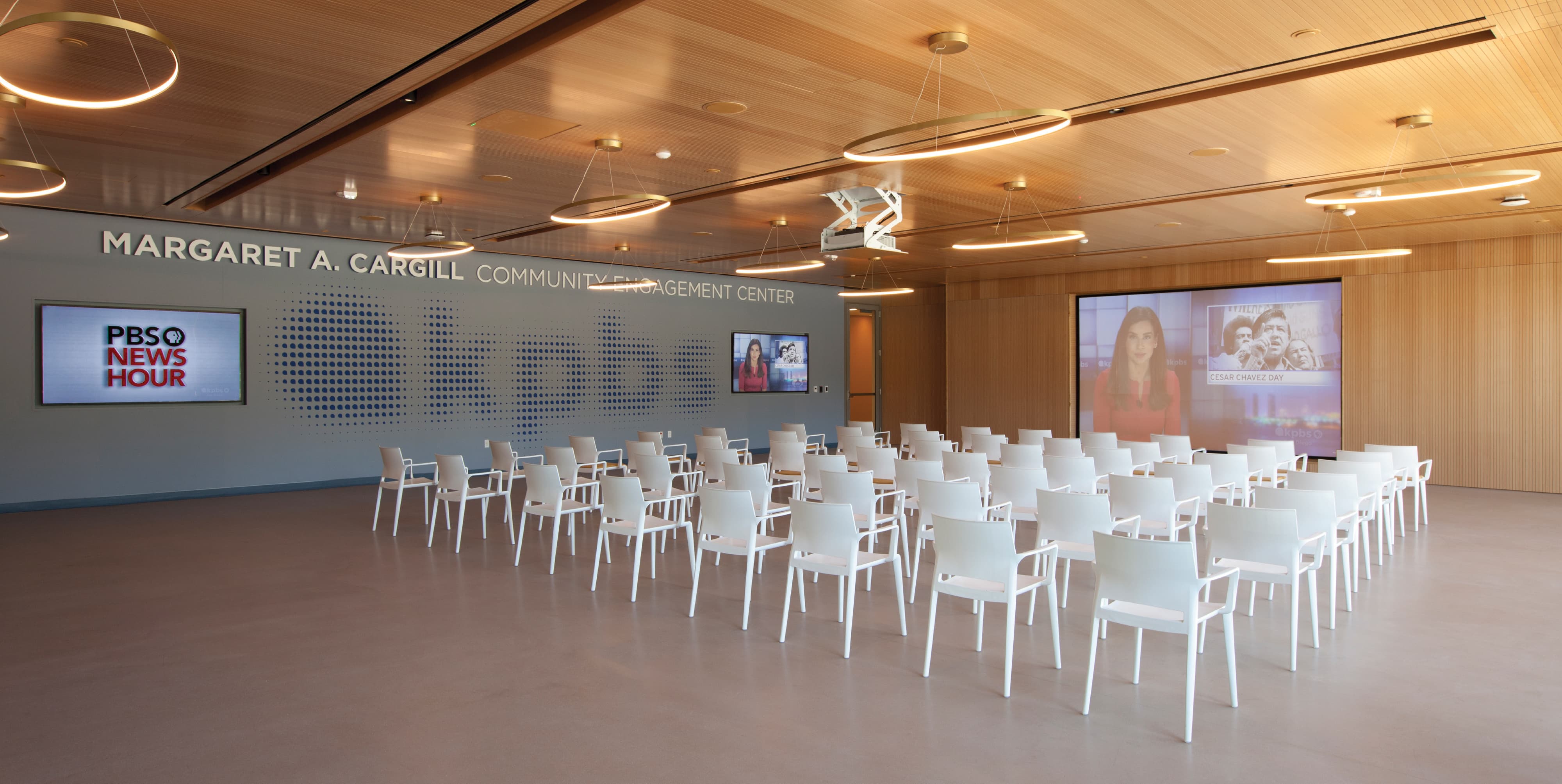 Flexible community engagement space at the Margaret A. Cargill Community Engagement Center featuring integrated environmental graphic design, branded storytelling, and digital media displays, showcasing RSM Design expertise in experiential design, placemaking, and wayfinding for civic, cultural, and education environments.