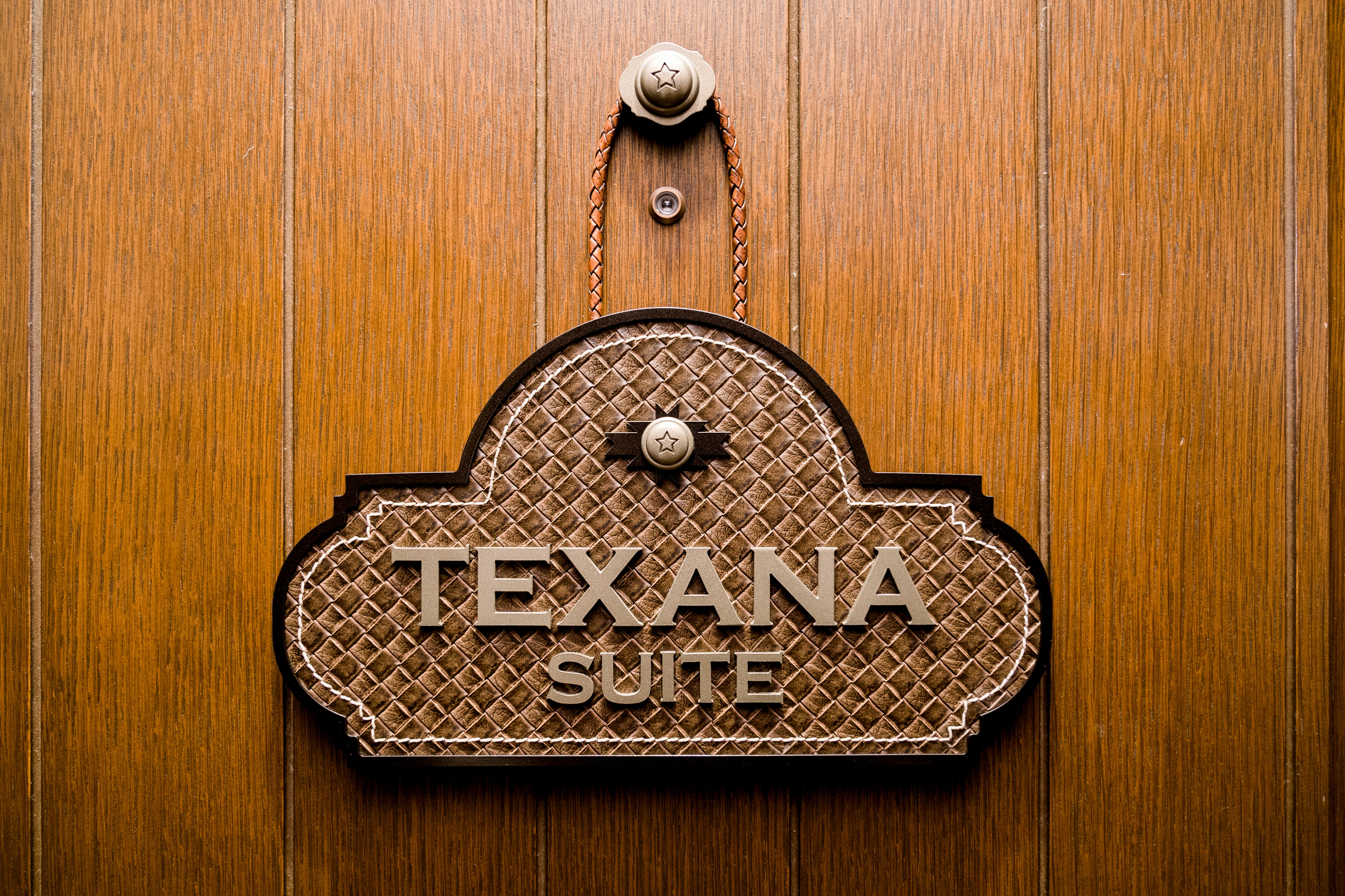 Close up shot of Texana Suite hanging wall decorative plaque for The Drover Hotel in Fort Worth, Texas. 
