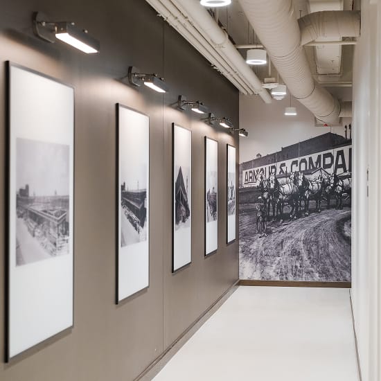 The Armour Stockyards corridor with framed historic photos and Armour and Company mural, environmental graphic design by RSM Design