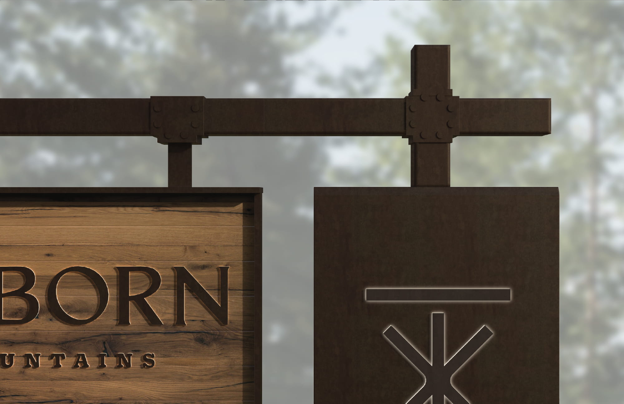 Close-up detail of Trailborn Rocky Mountains monument sign featuring routed wood lettering and a dark metal hanging panel with an illuminated brand icon, showcasing specialty graphics and signage design for a hospitality environment by RSM Design.
