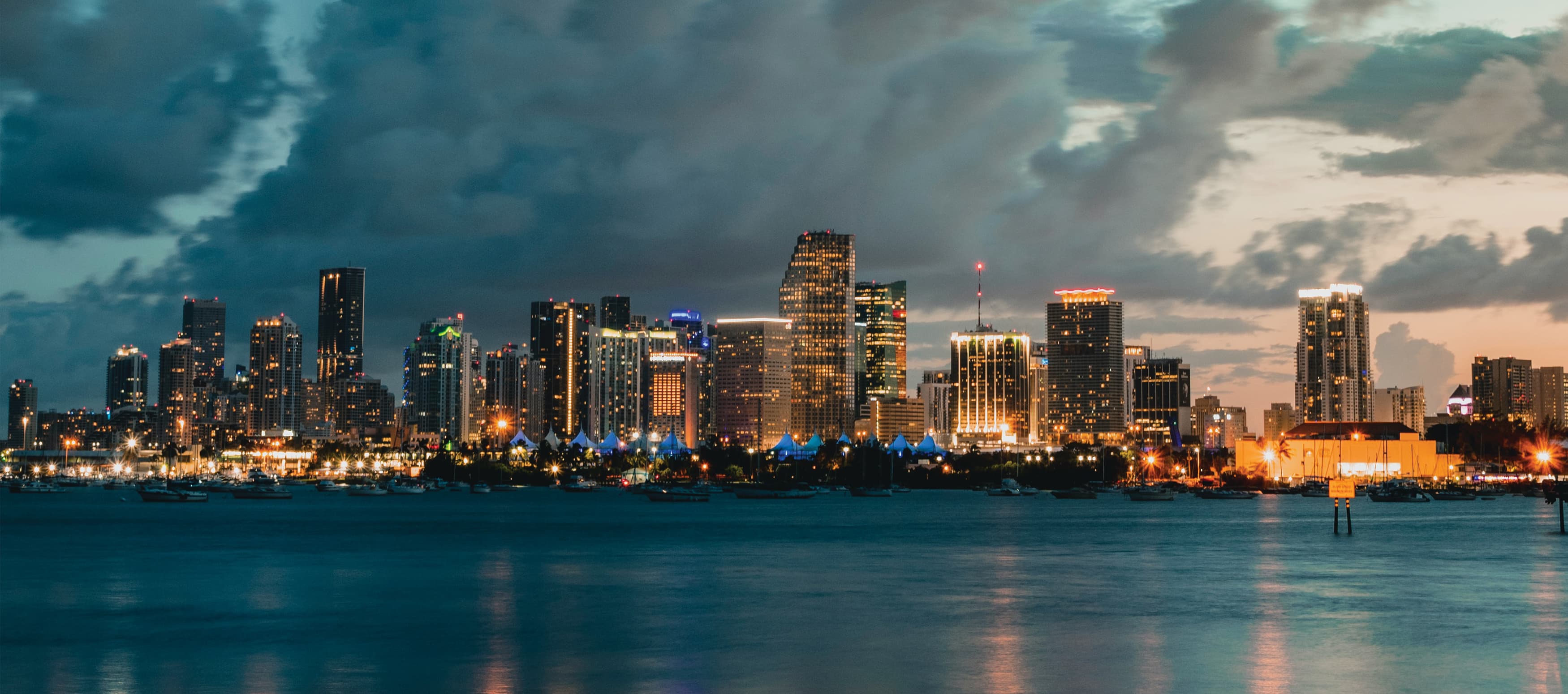 A nighttime conceptual rendering showing illuminated light poles along the water's edge.