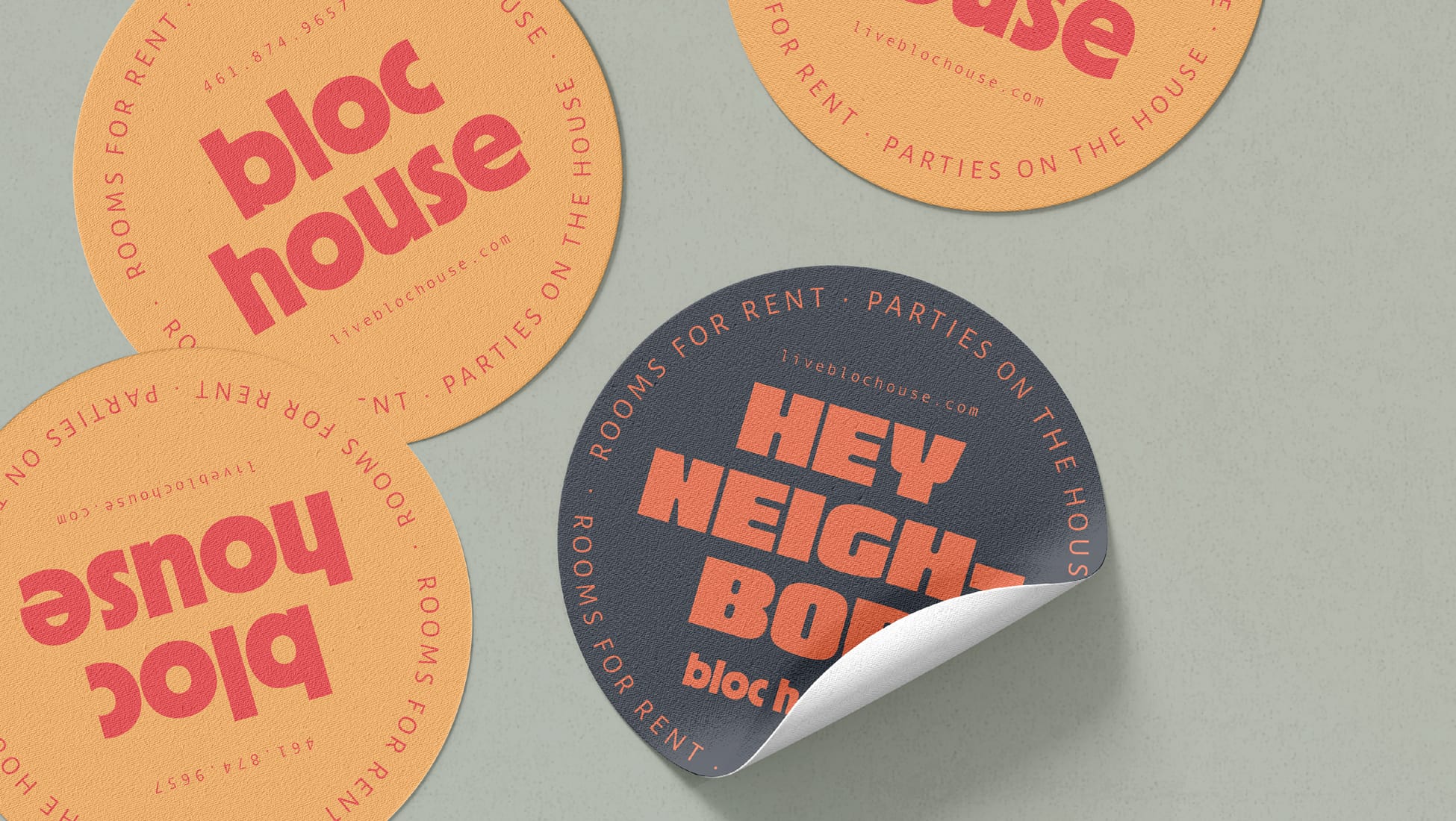 Branded sticker mockup for Bloc House, showing a collection of round stickers in orange and dark navy. The orange stickers feature the "bloc house" wordmark in bold red type with the taglines "Rooms for Rent · Parties on the House" and "liveblochouse.com" along the border. A partially peeled navy sticker in the foreground reads "Hey Neighbor" in large orange type with the bloc house name below.