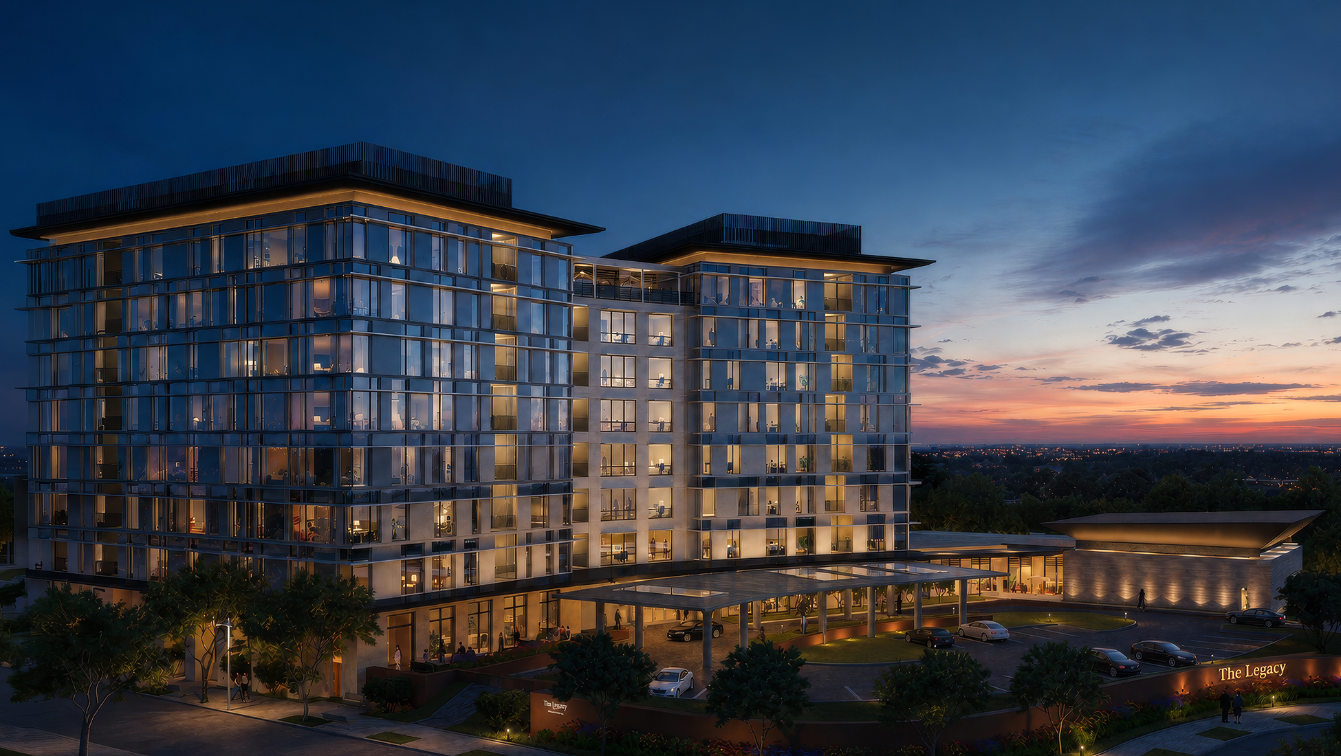 Rendering of a tall illuminated glass high-rise building at twilight, with a covered porte cochère entrance, a 'The Legacy' monument sign, valet drop-off, and landscaped grounds, set against a colorful sunset skyline.