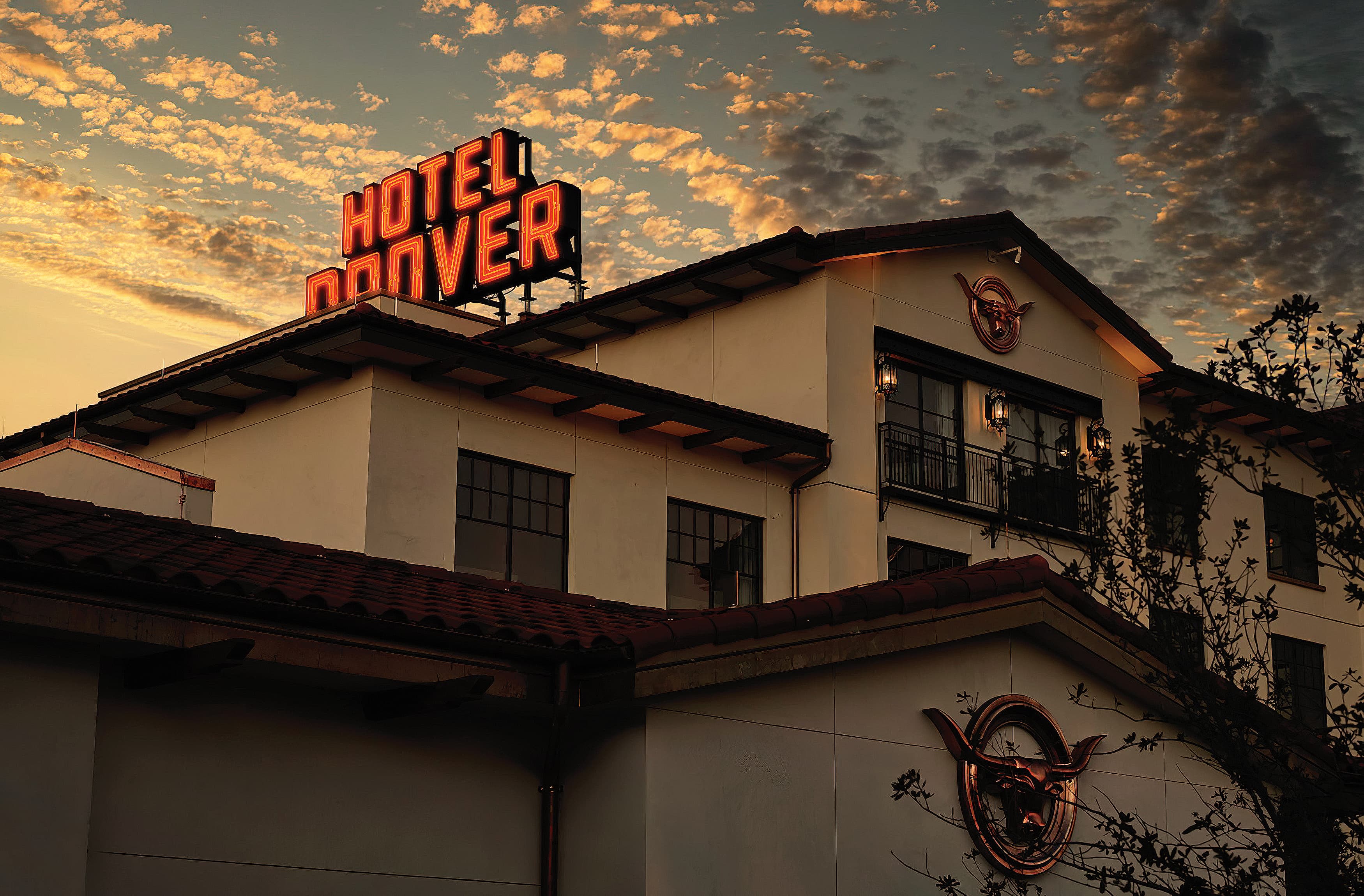 Orange neon exterior rooftop identity for The Drover Hotel in Fort Worth, Texas. 