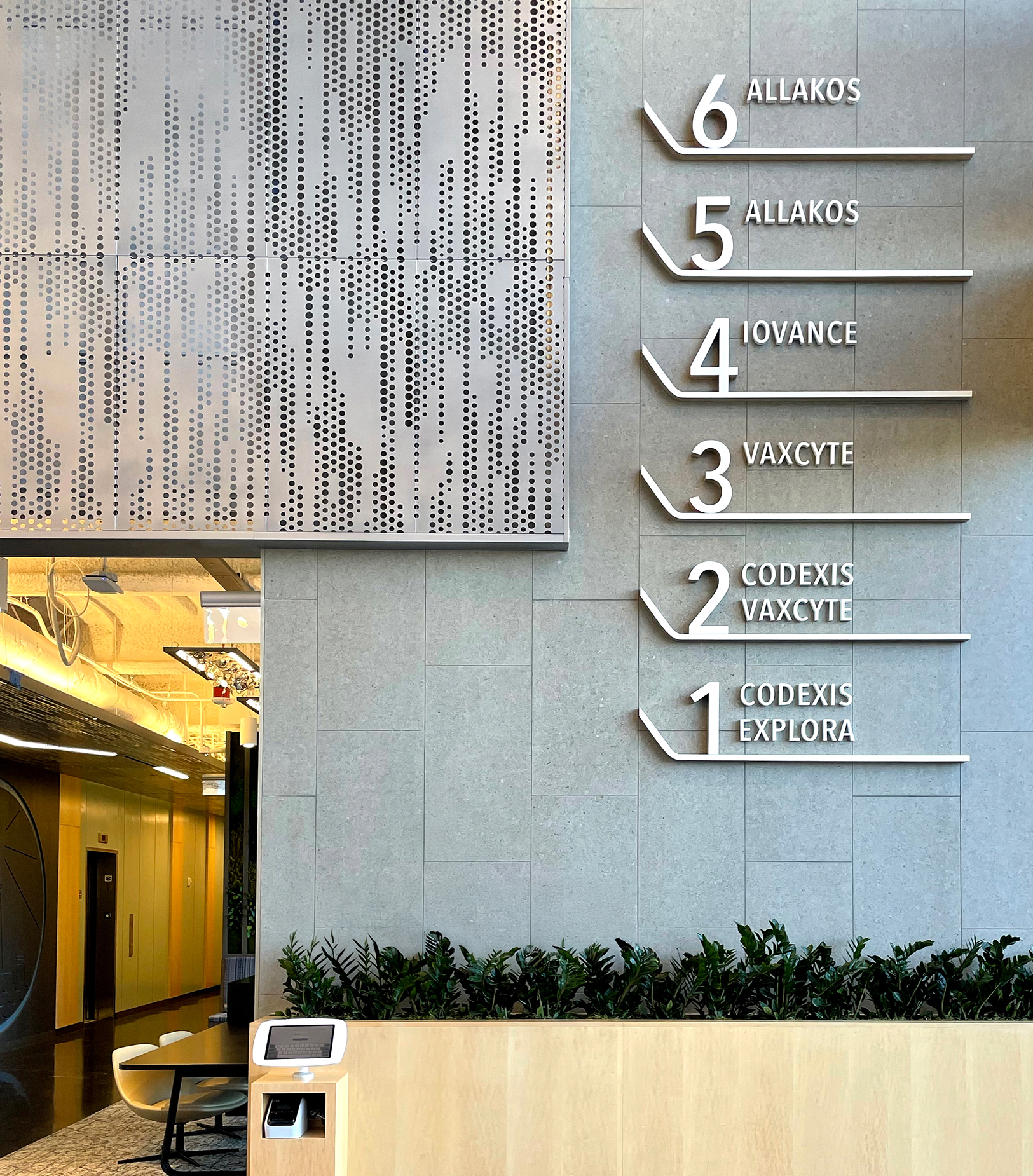 Interior lobby directory sign with dimensional floor-by-floor tenant listing and perforated metal art panel at 825 San Carlos office building, wayfinding and environmental graphic design by RSM Design