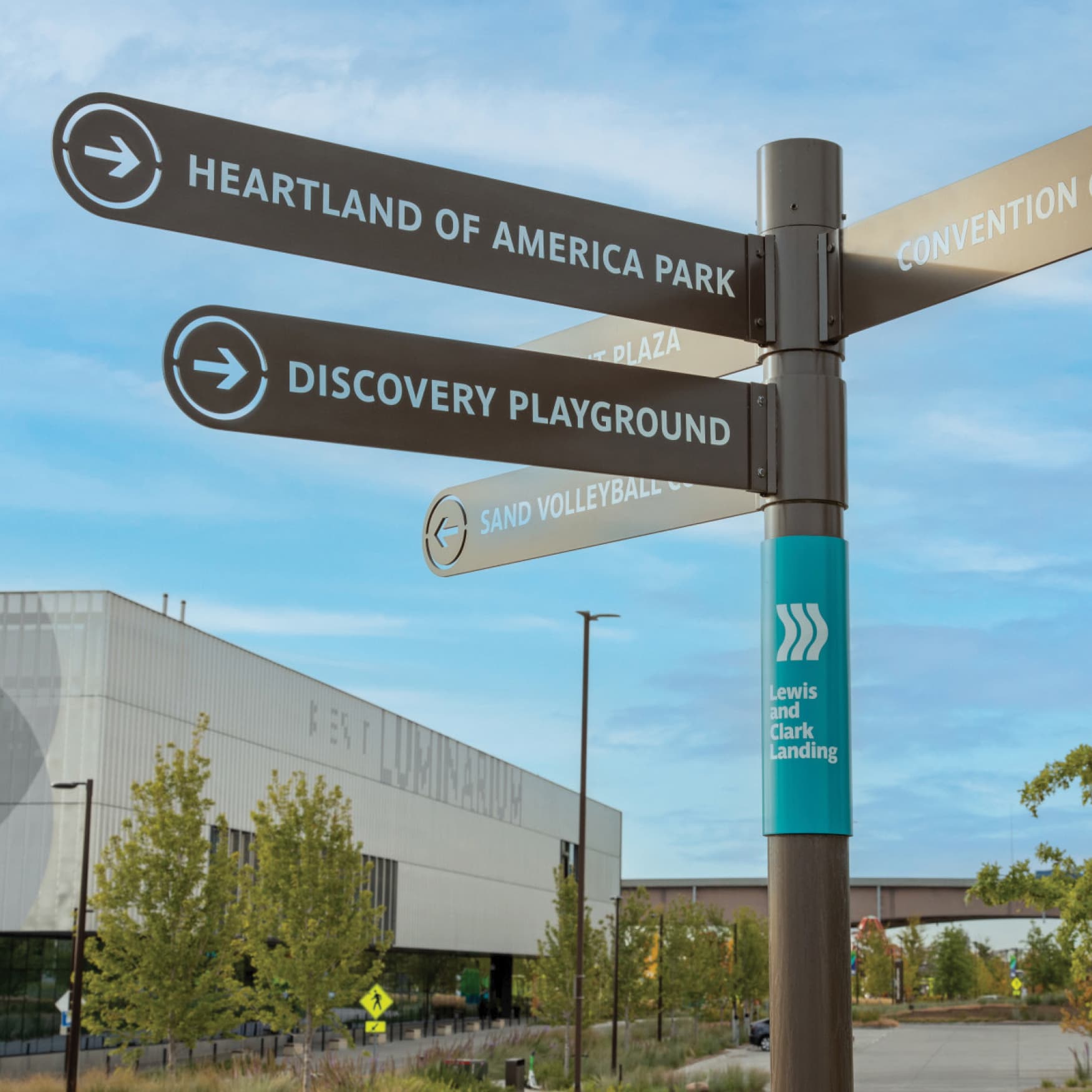 Directional signage with Omaha RiverFront brand applied, designed by RSM Design. Directional signage from Heartland of America Park, Discovery Playground, Sand Volleyball Court at the Lewis and Clark Landing Park. 