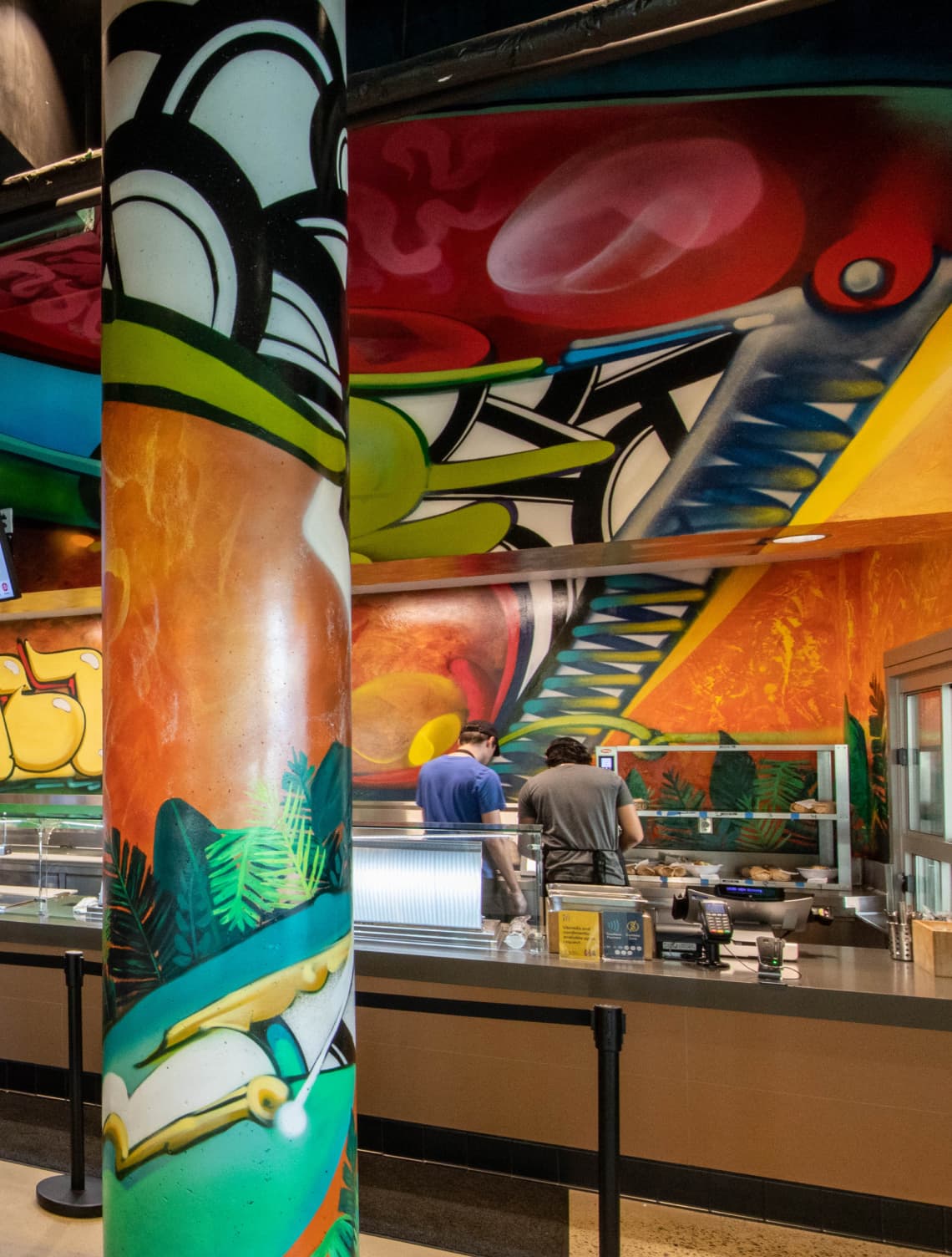 Detail image of Wolftown's painted mural by Max Moses with bold colors and graphics for UC San Diego Sixth College's dining hall by RSM Design in San Diego, California. 