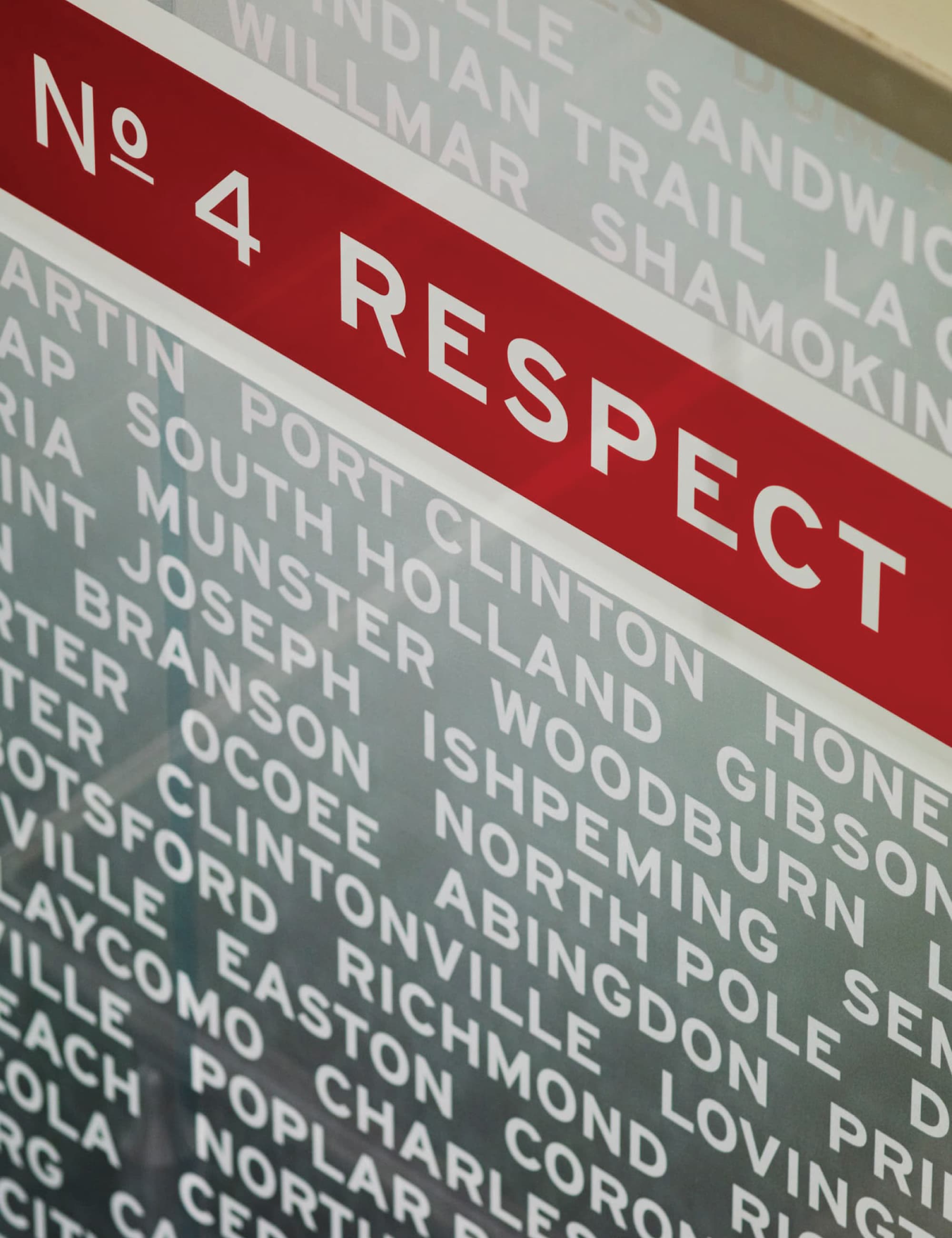 Close-up of donor recognition wall with engraved names and a “Respect” category marker, illustrating environmental graphic design, donor recognition programming, and experiential storytelling within higher education and cultural institution environments.