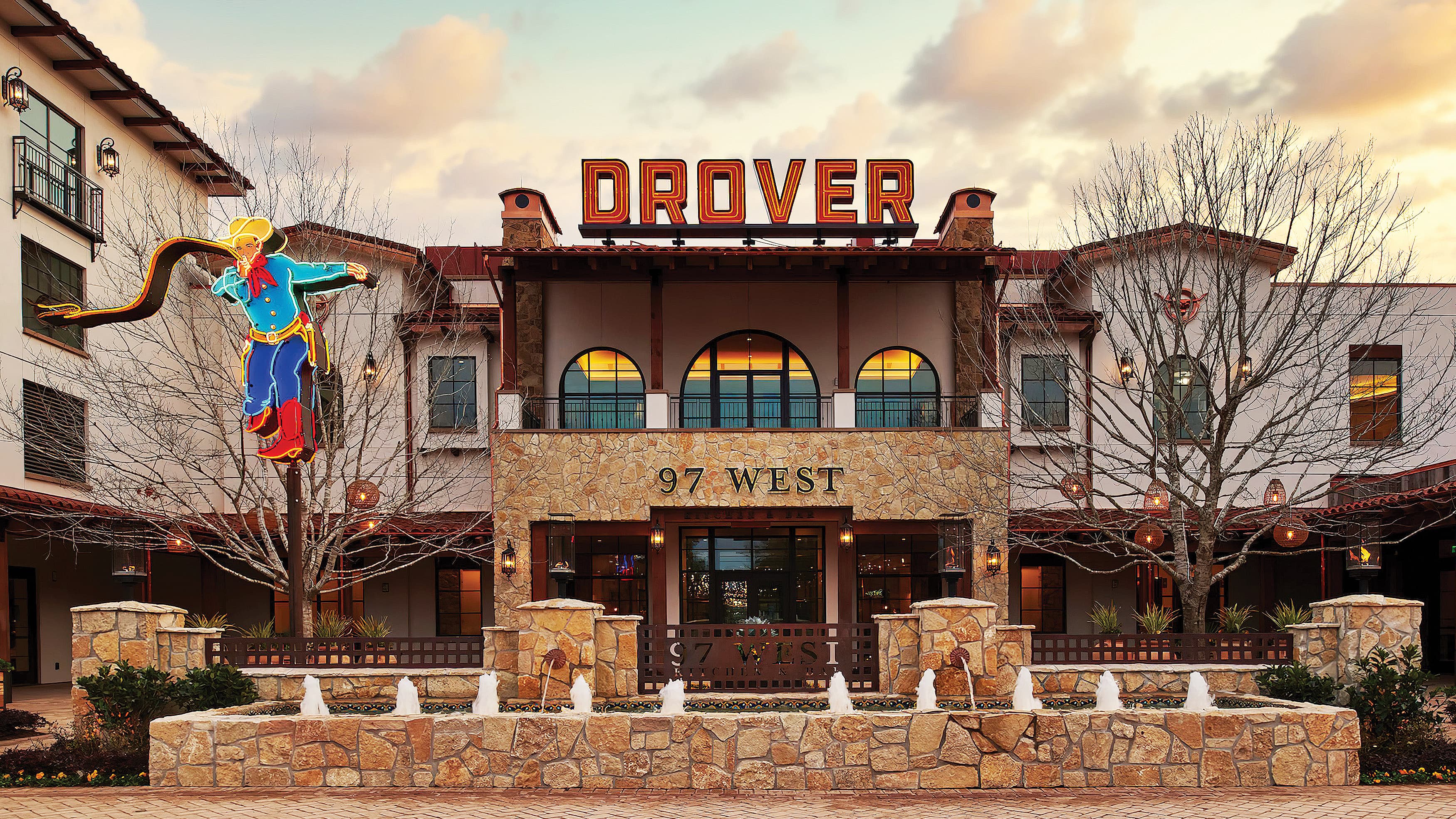Exterior entrance of Hotel Drover in Fort Worth, Texas with rooftop neon signage design by RSM Design.