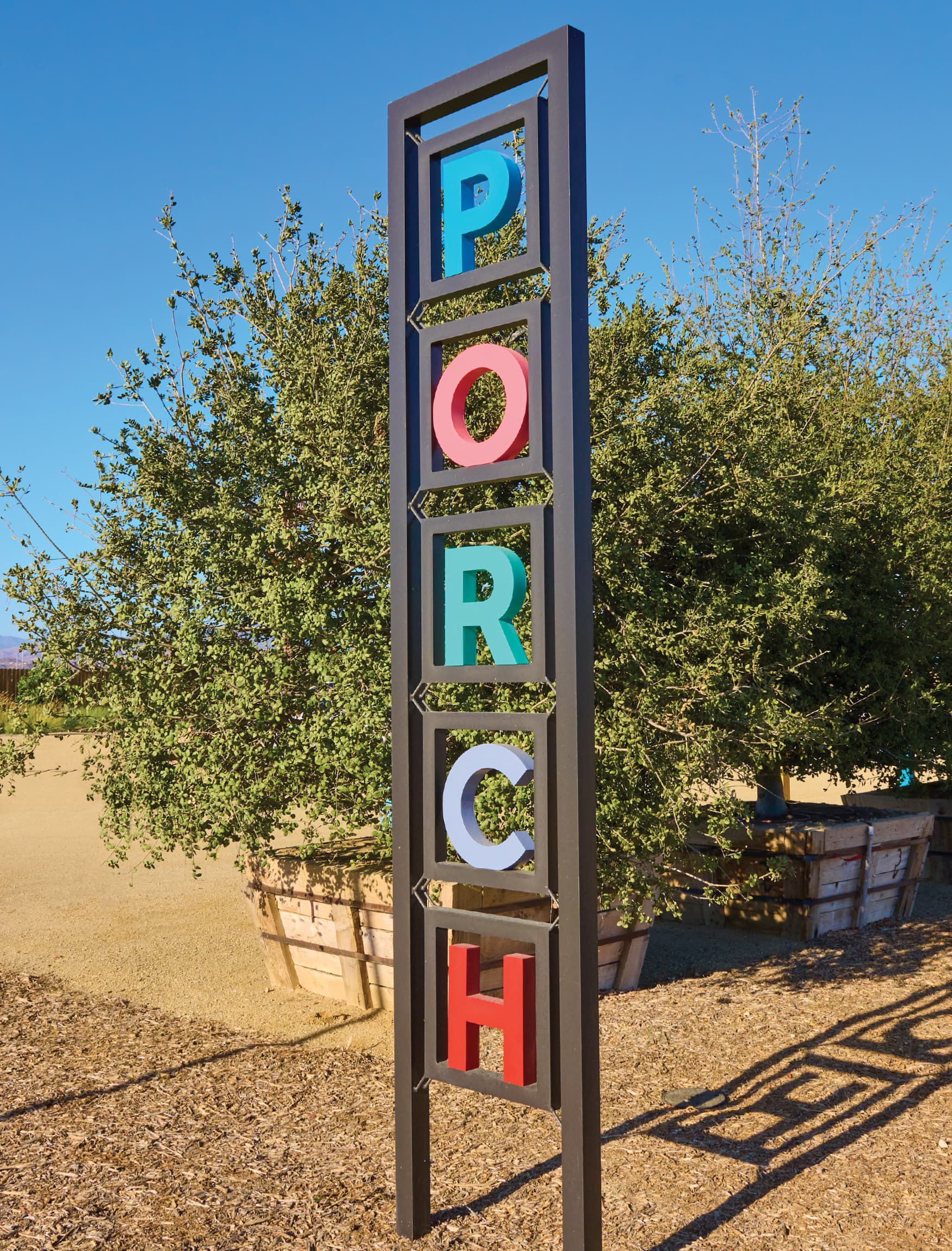 Vertical wayfinding identity signage for the Porch at Valencia. Designed by RSM Design. 