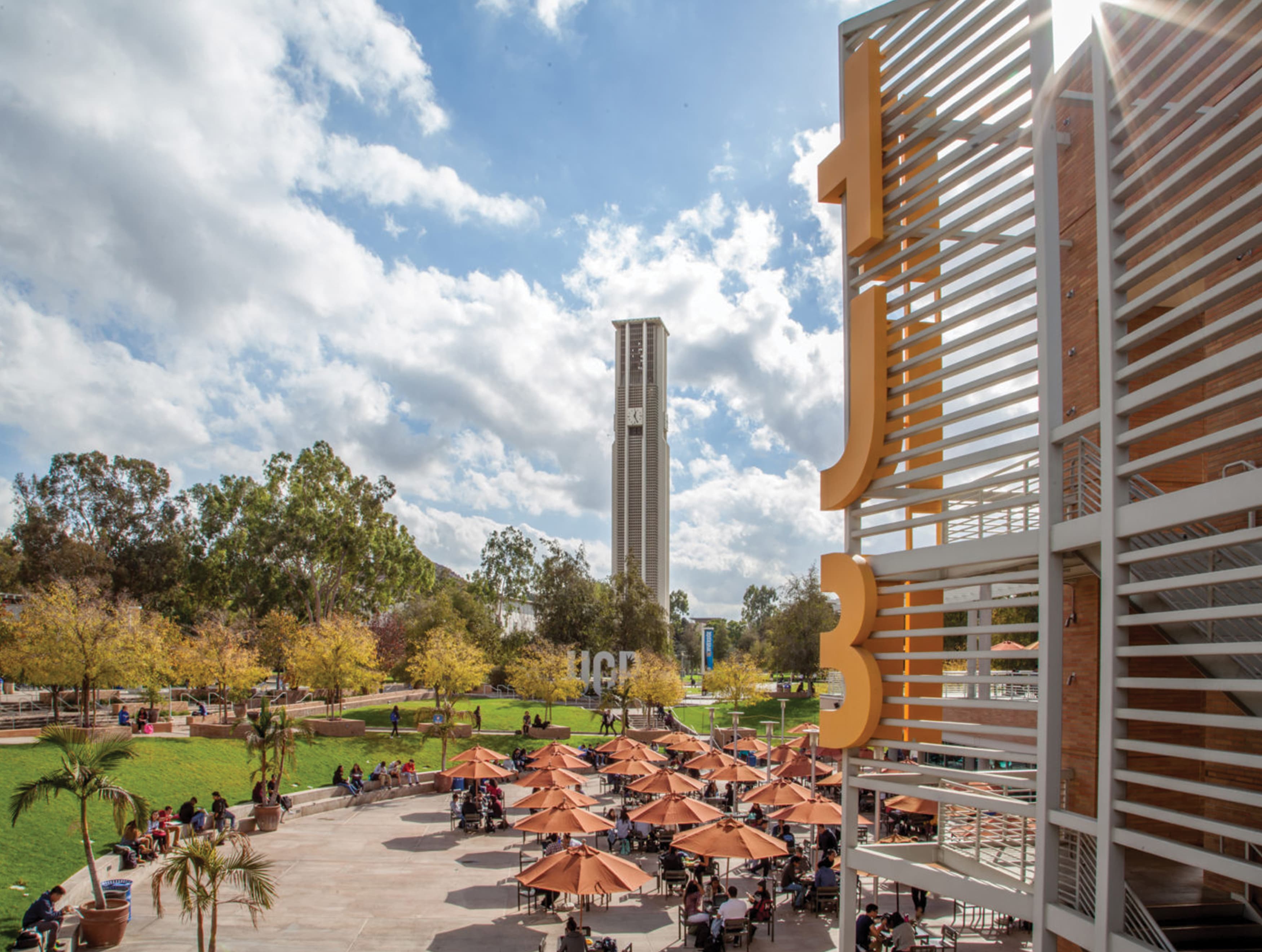 A plaza featuring signage and open-air seating on the campus of UCR.