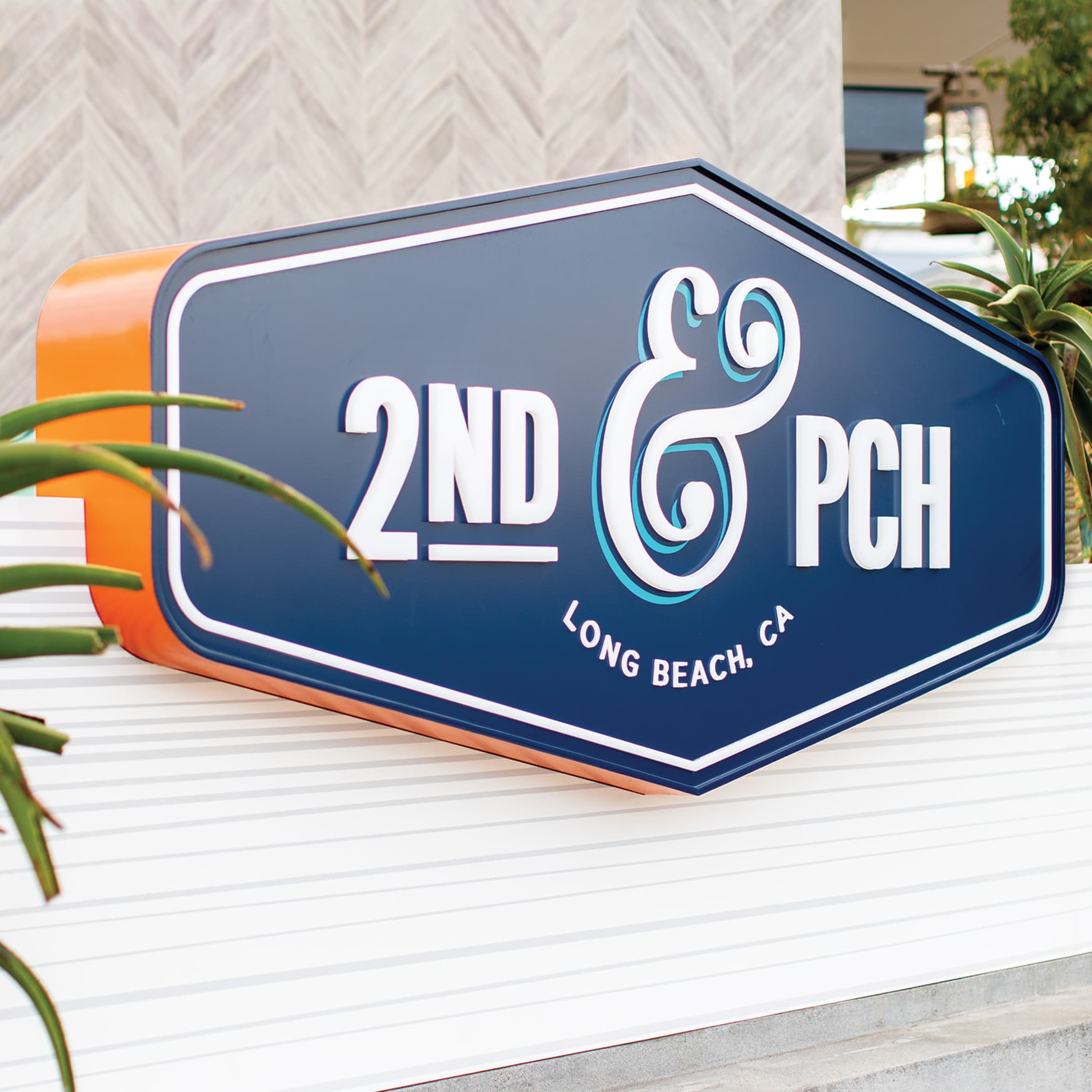 2nd & PCH blue and orange identity signage in Long Beach, California