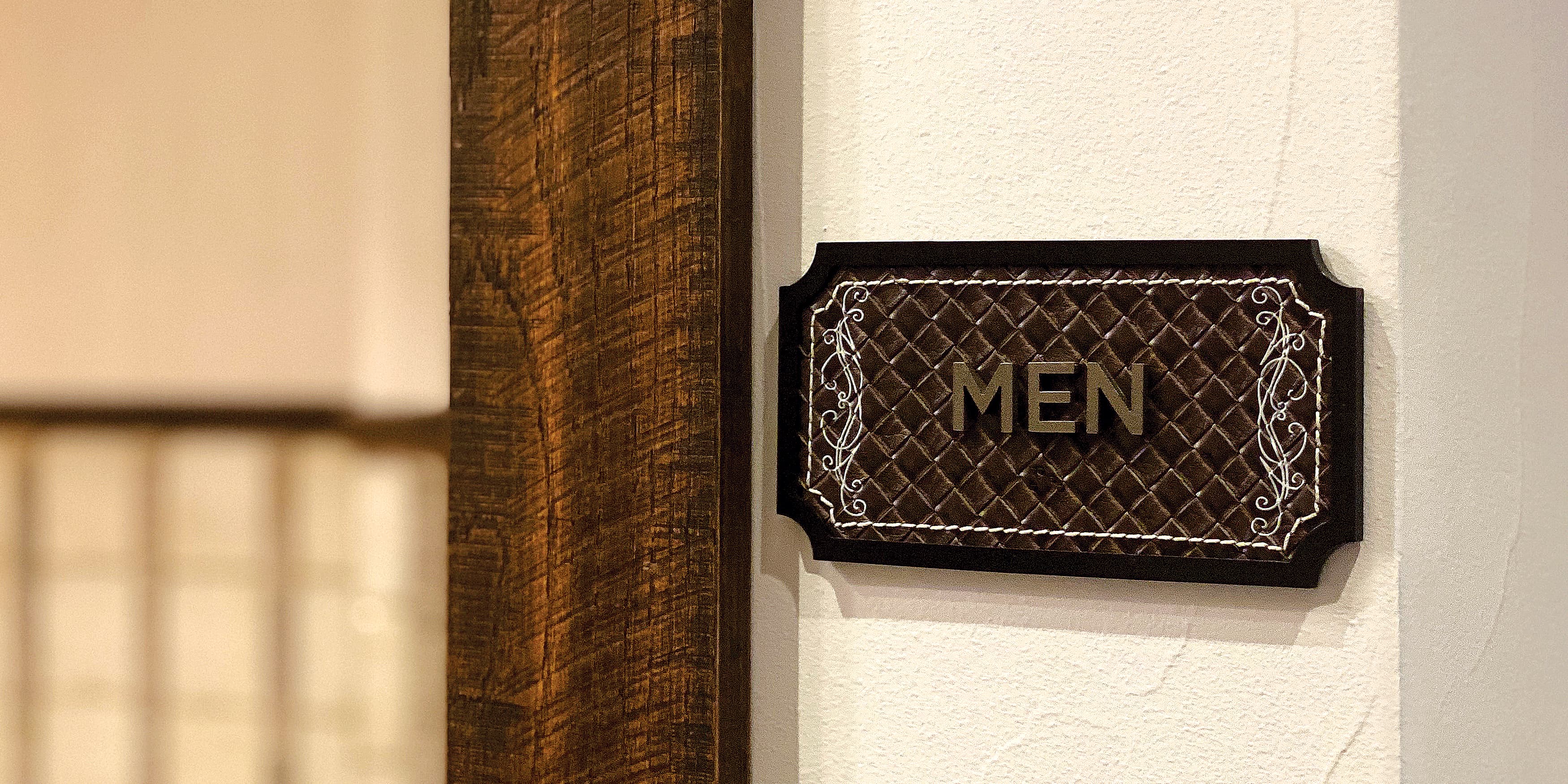 Men's restroom signage directional for The Drover Hotel in Fort Worth, Texas.