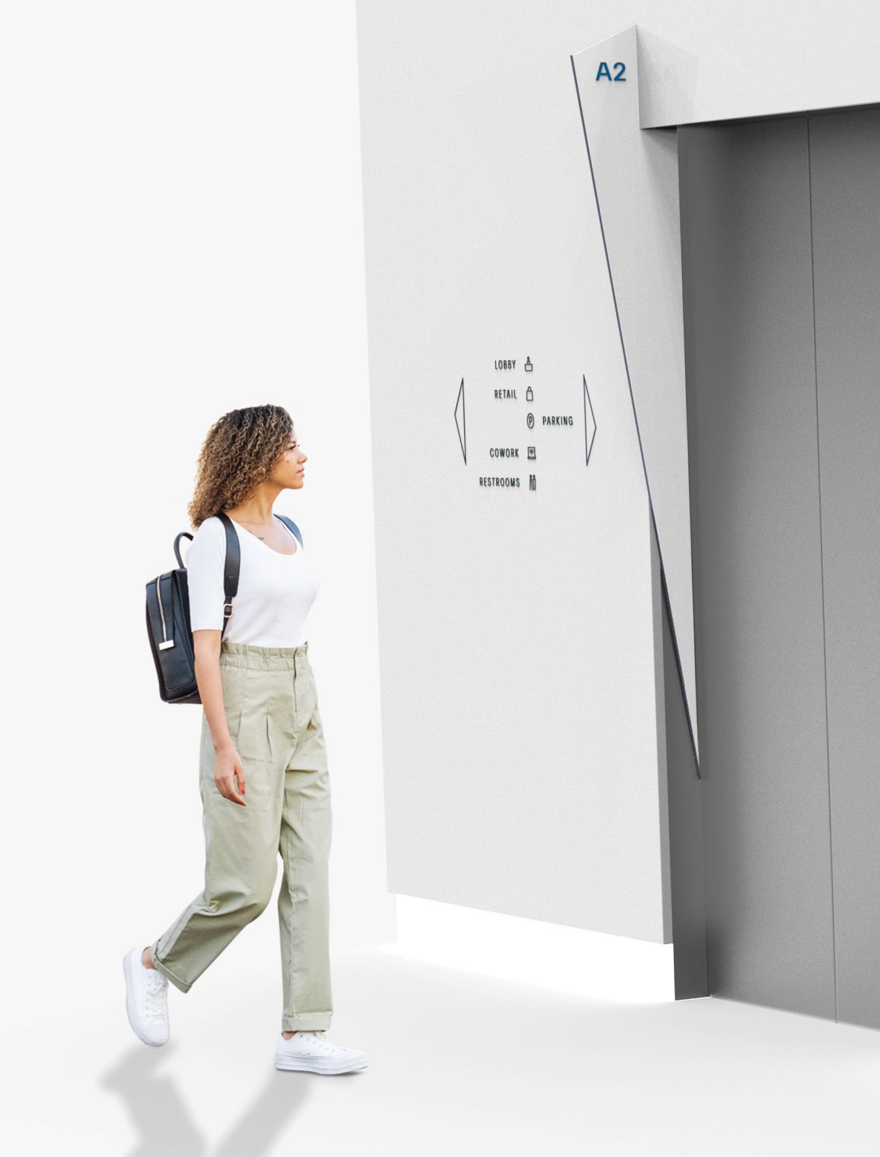 Image of a women walking by the elevator directory at 1121 Symphony Square. 