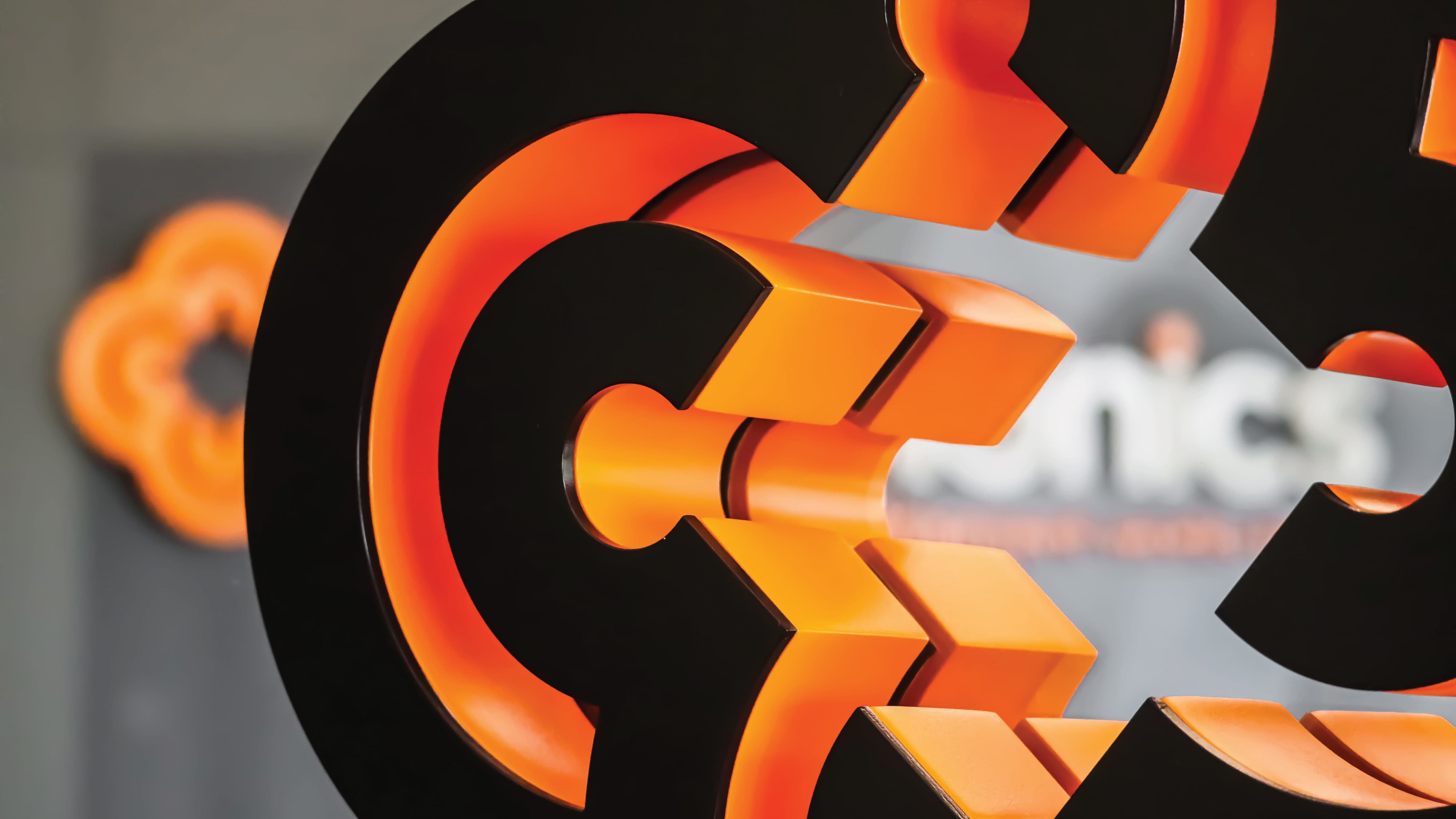 Illuminated branded logo installation with dimensional lettering and integrated lighting, demonstrating environmental graphic design, brand identity, and experiential signage for retail, entertainment, and mixed-use destinations.