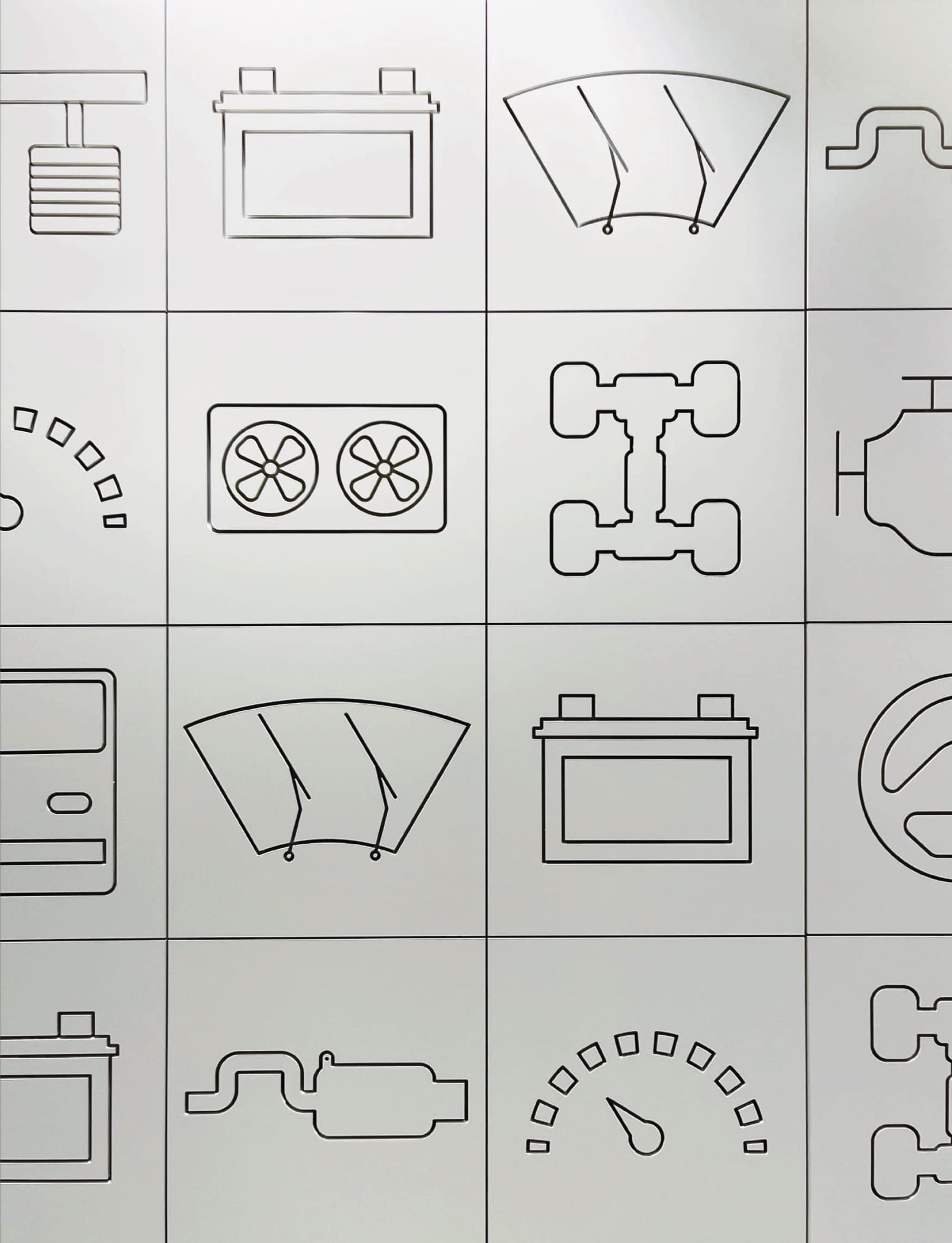 Custom environmental graphic design icon system featuring automotive components displayed in a grid, illustrating wayfinding design, branded environments, and experiential graphics for mobility, workplace, and mixed-use destinations.