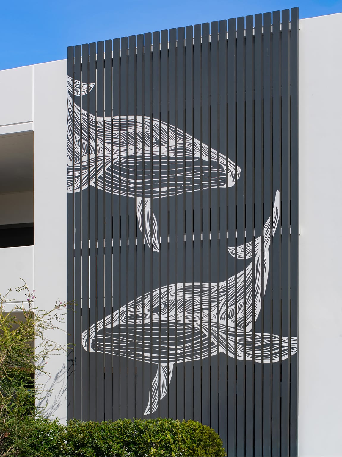 Dana Point Harbor parking structure facade with large-scale whale environmental graphics on slatted screen — environmental graphic design by RSM Design