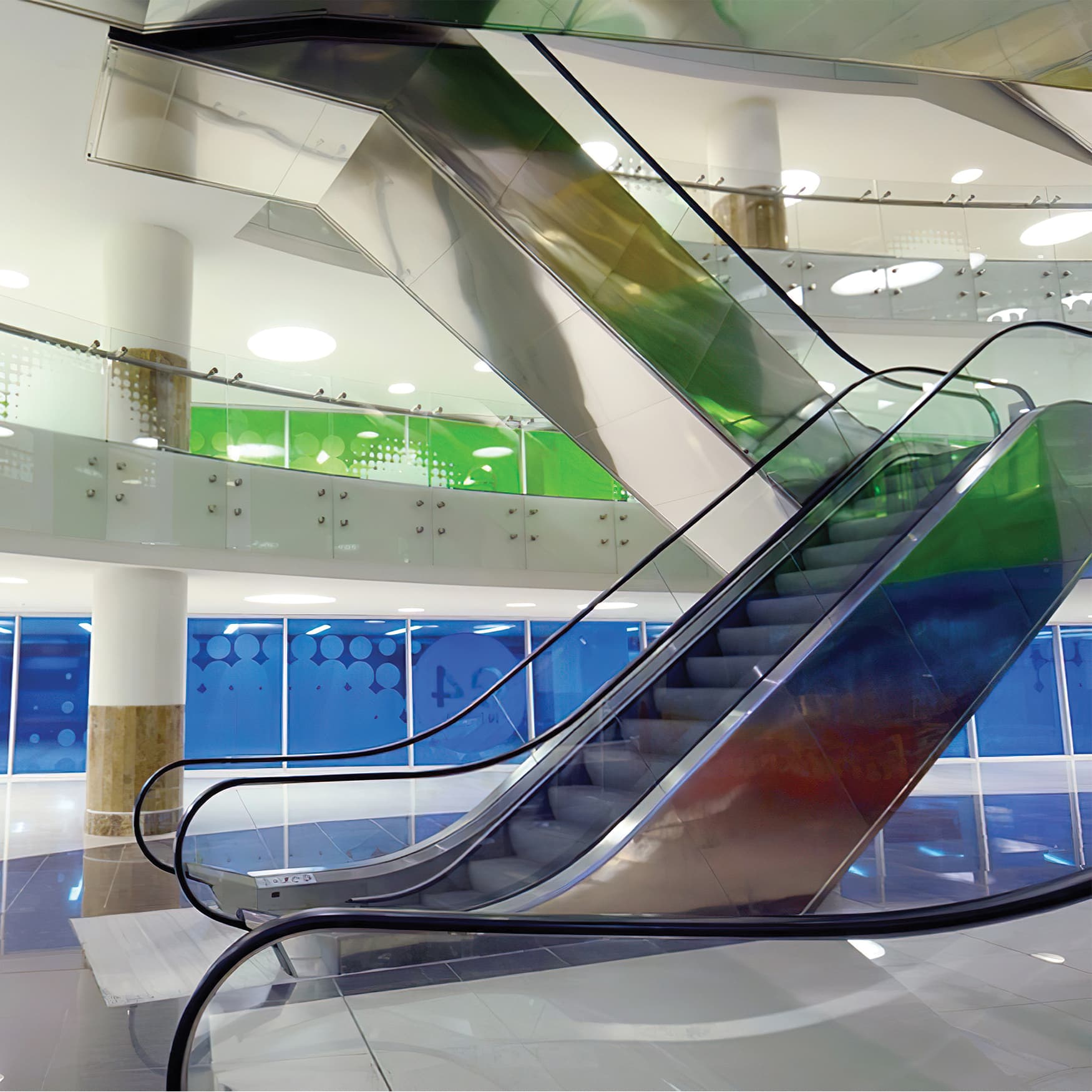 Interior elevators with color coded levels and tinted glass supergraphics.