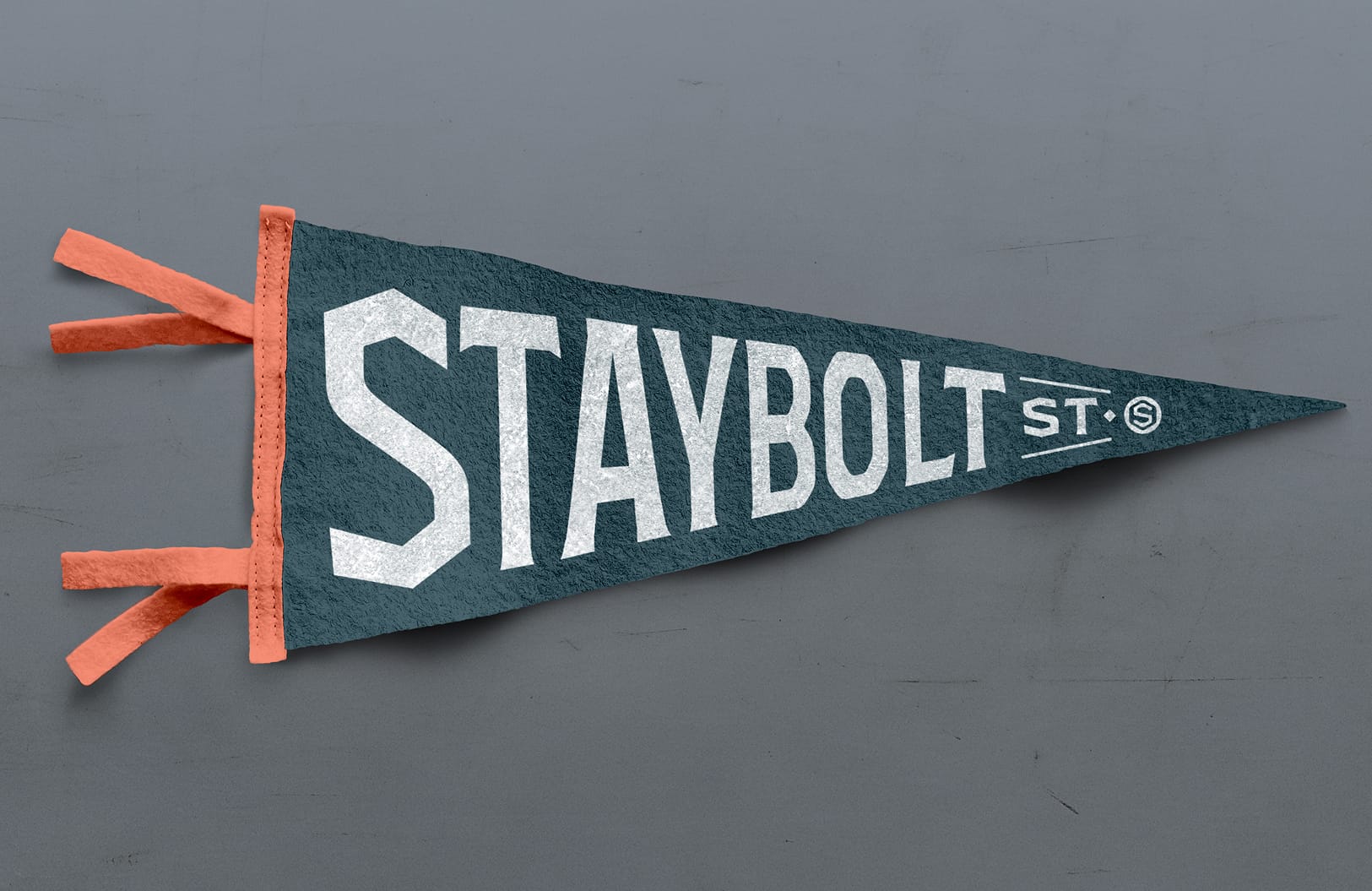 Staybolt Street branded felt pennant with distressed typography and identity mark — branding by RSM Design