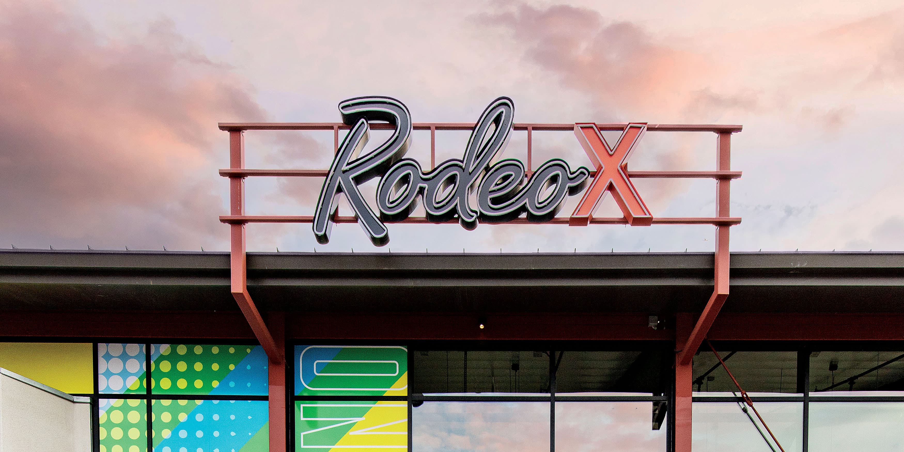 Neon Rodeo X overhead rooftop master retail signage for New Haven Marketplace in Ontario, California. 