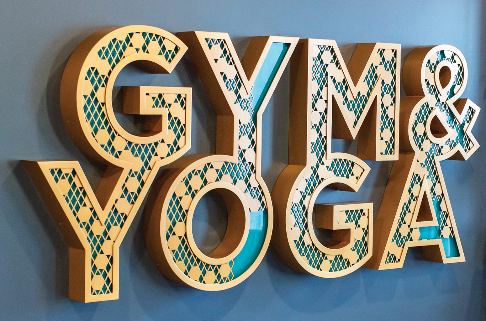 Persea residential community Gym and Yoga dimensional letter signage with geometric pattern cutouts, environmental graphic design by RSM Design