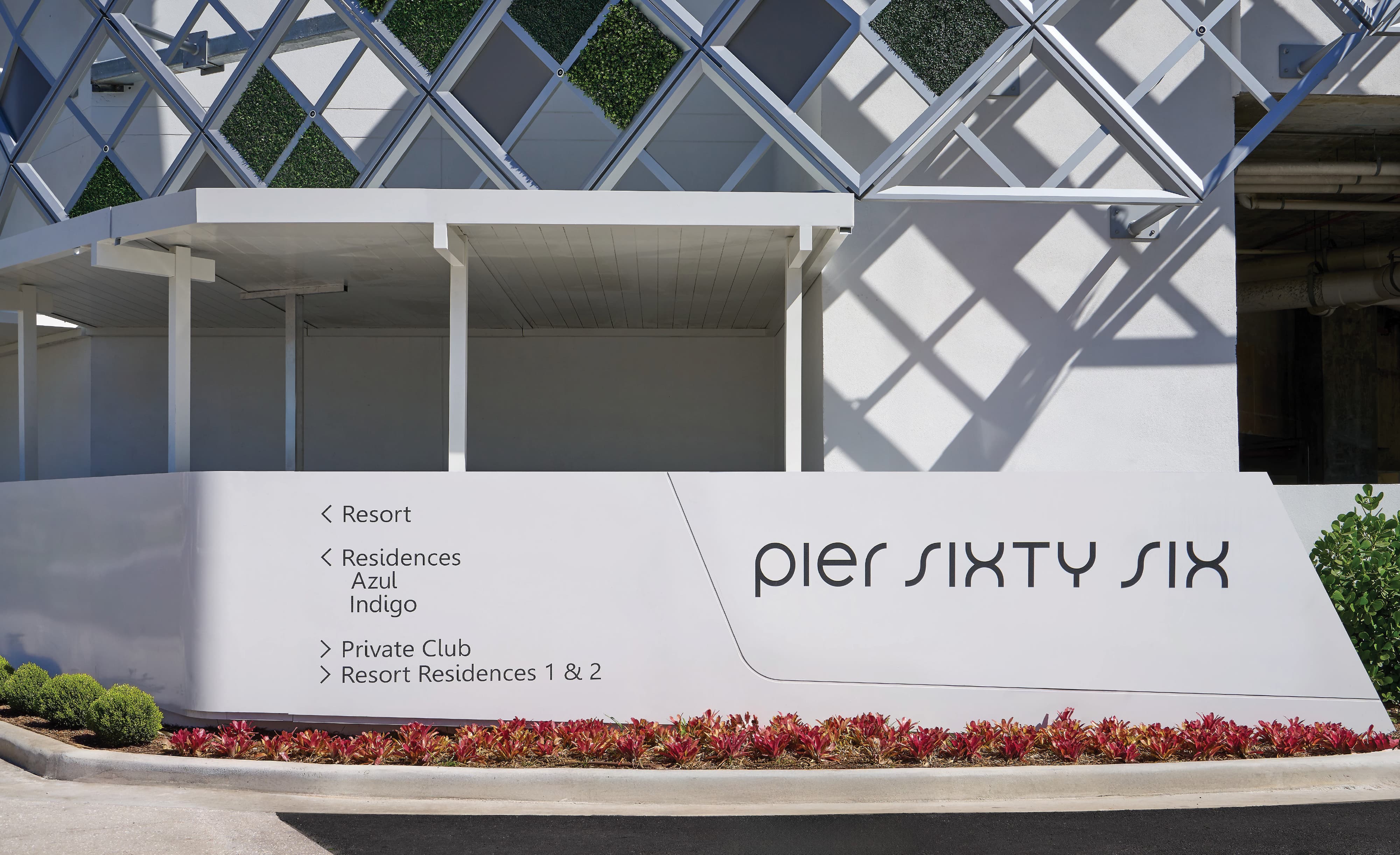 Pier Sixty-Six primary entry monument sign with vehicular wayfinding directing guests to the resort, residences Azul and Indigo, private club, and resort residences 1 and 2, set against a diamond-patterned living wall structure in Fort Lauderdale, Florida — RSM Design wayfinding and signage design, master sign programs, branding and visual identity, and environmental graphic design for hospitality, waterfront, and residential community destinations.