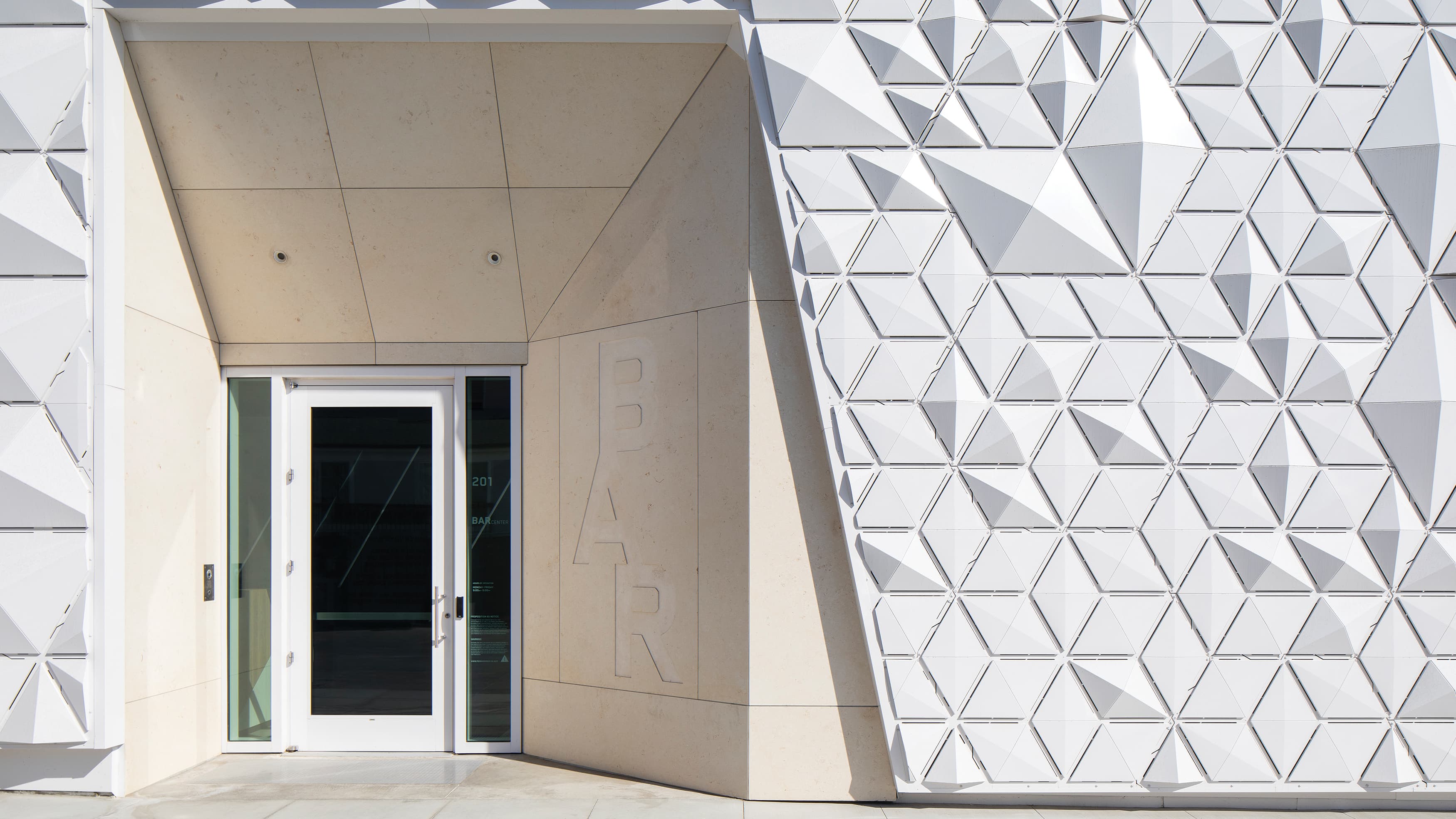 Geometric entry facade and etched stone signage at The BAR Center at the Beach in Venice, California
