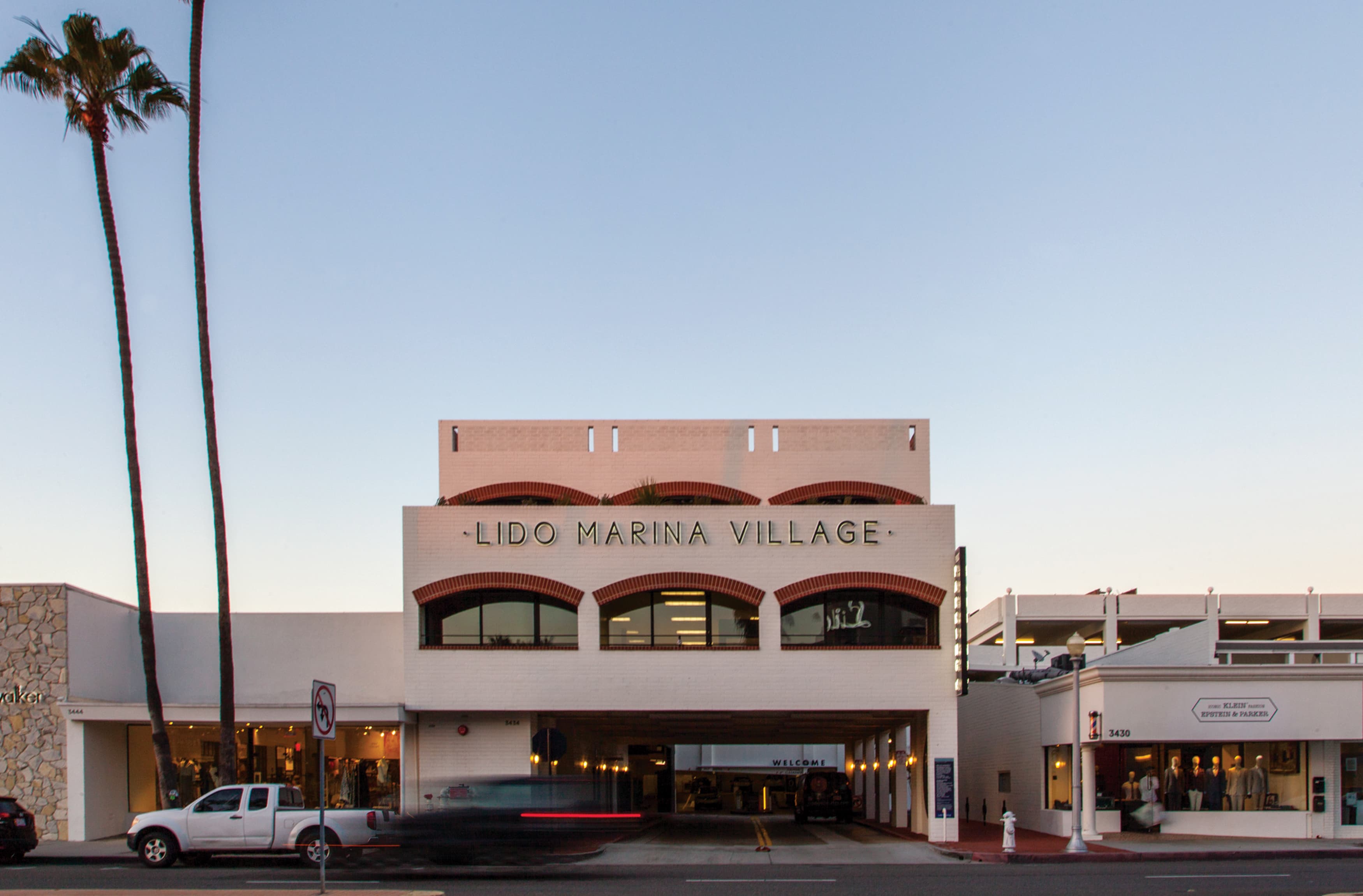 Image of the Lido Marina Village parking garage from the street at sunset. Signage by RSM Design. Located in Newport Beach, California. 