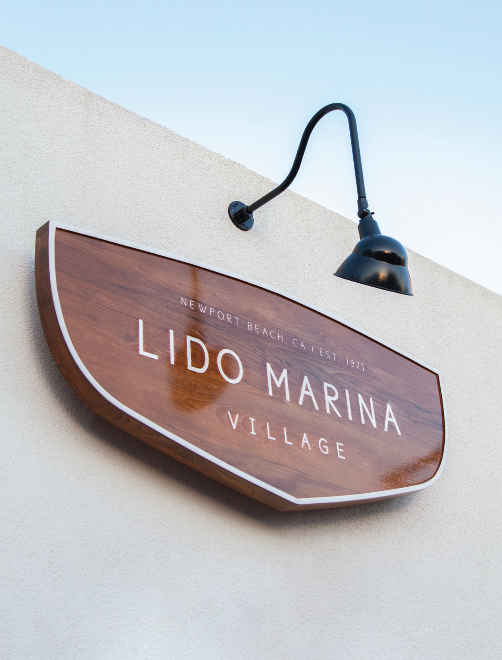 Image of the wooden nautical sign designed by RSM Design for Lido Marina Village, a luxury waterfront shopping district in Newport Beach, CA. 