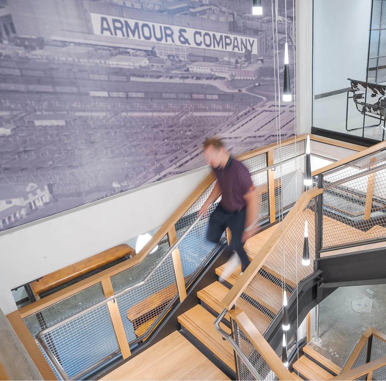The Armour Stockyards stairwell with historic Armour and Company photo mural, environmental graphic design by RSM Design