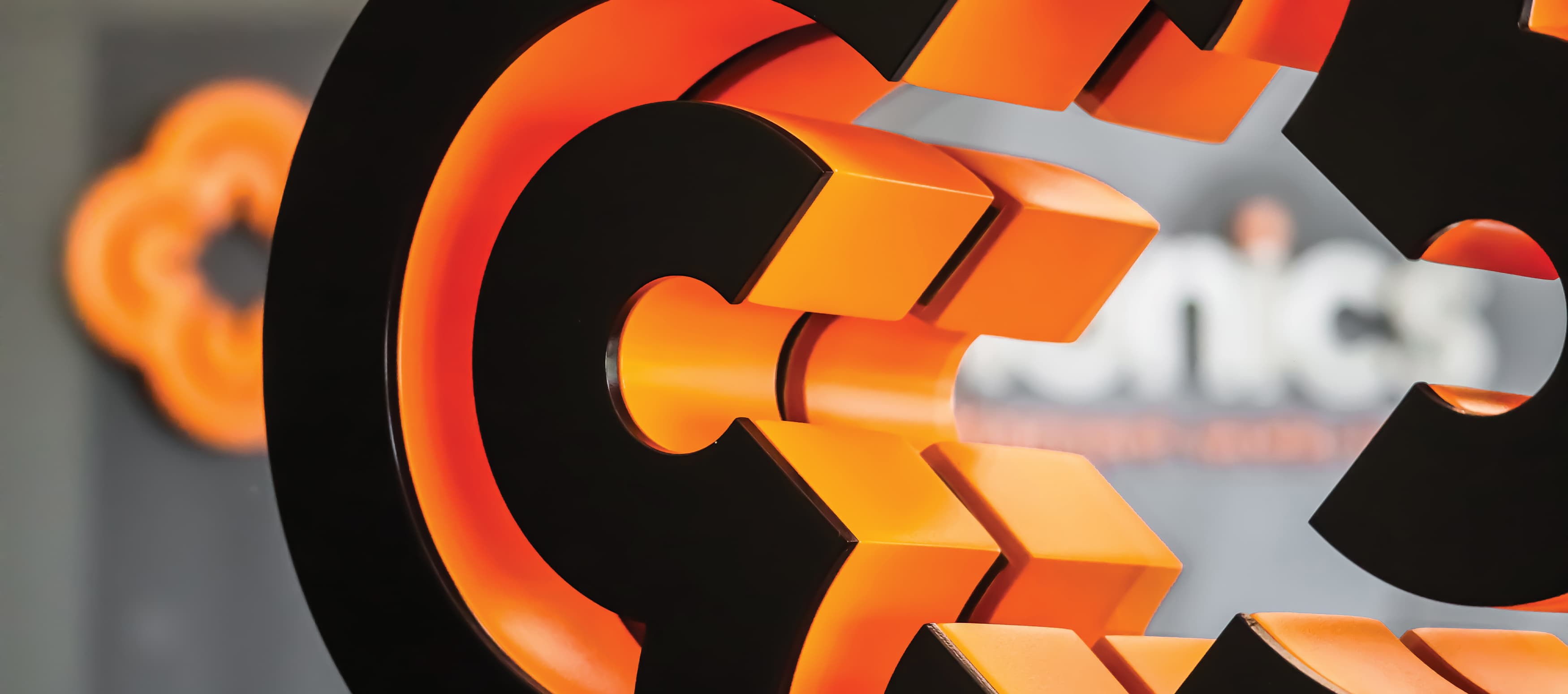 Detail shot of the Chemonics signage, outlined with a bold orange.