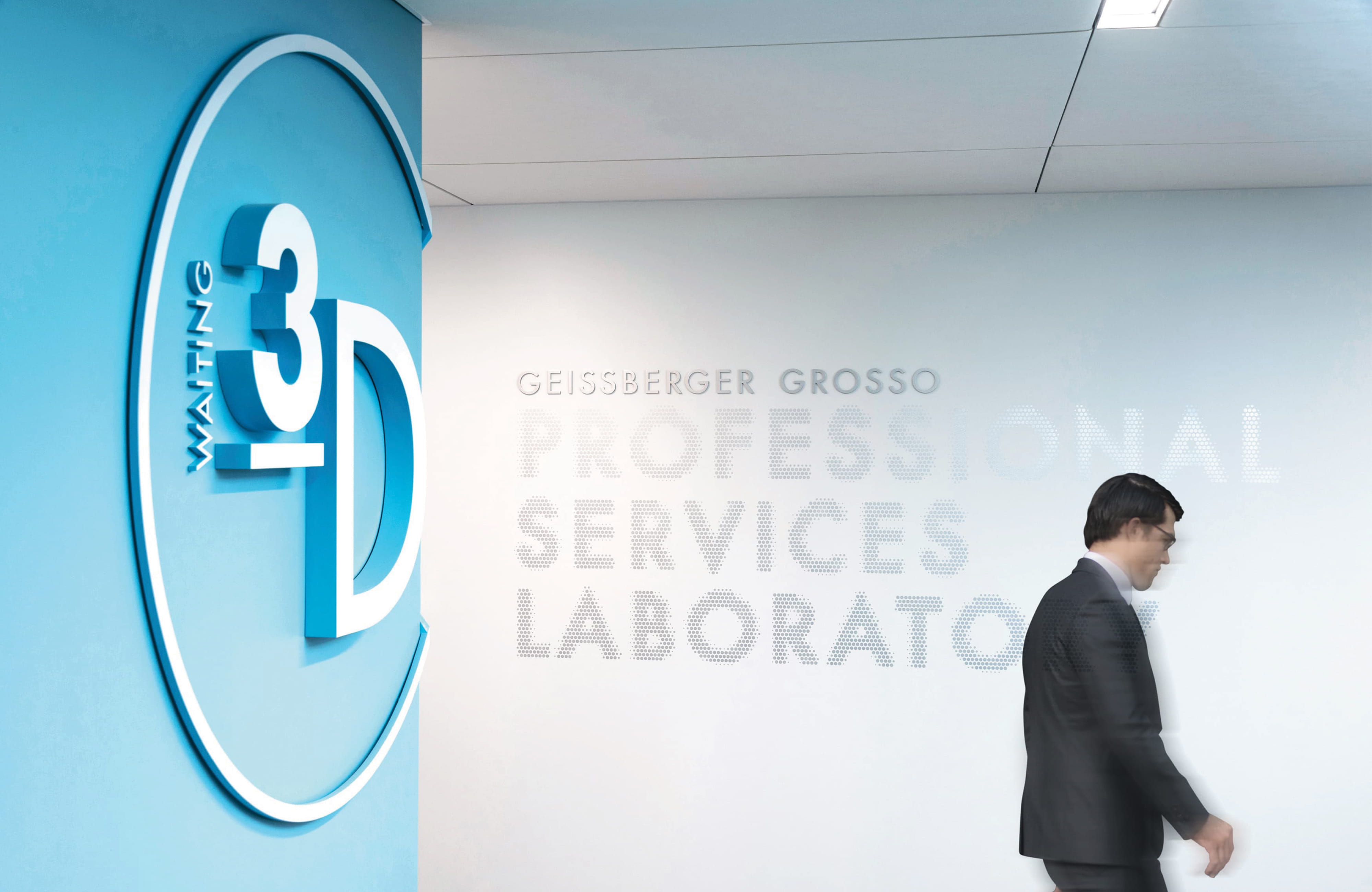 University of the Pacific interior corridor featuring a dimensional "Waiting 3D" room identification sign on a bold blue accent wall alongside a large-scale perforated dot-pattern wall graphic for the Geissberger Grosso Professional Services Laboratory, with a figure in motion — RSM Design branding and visual identity, specialty graphics, experiential graphics, branded environments, and environmental graphic design for education, health and wellness, and science and technology destinations.