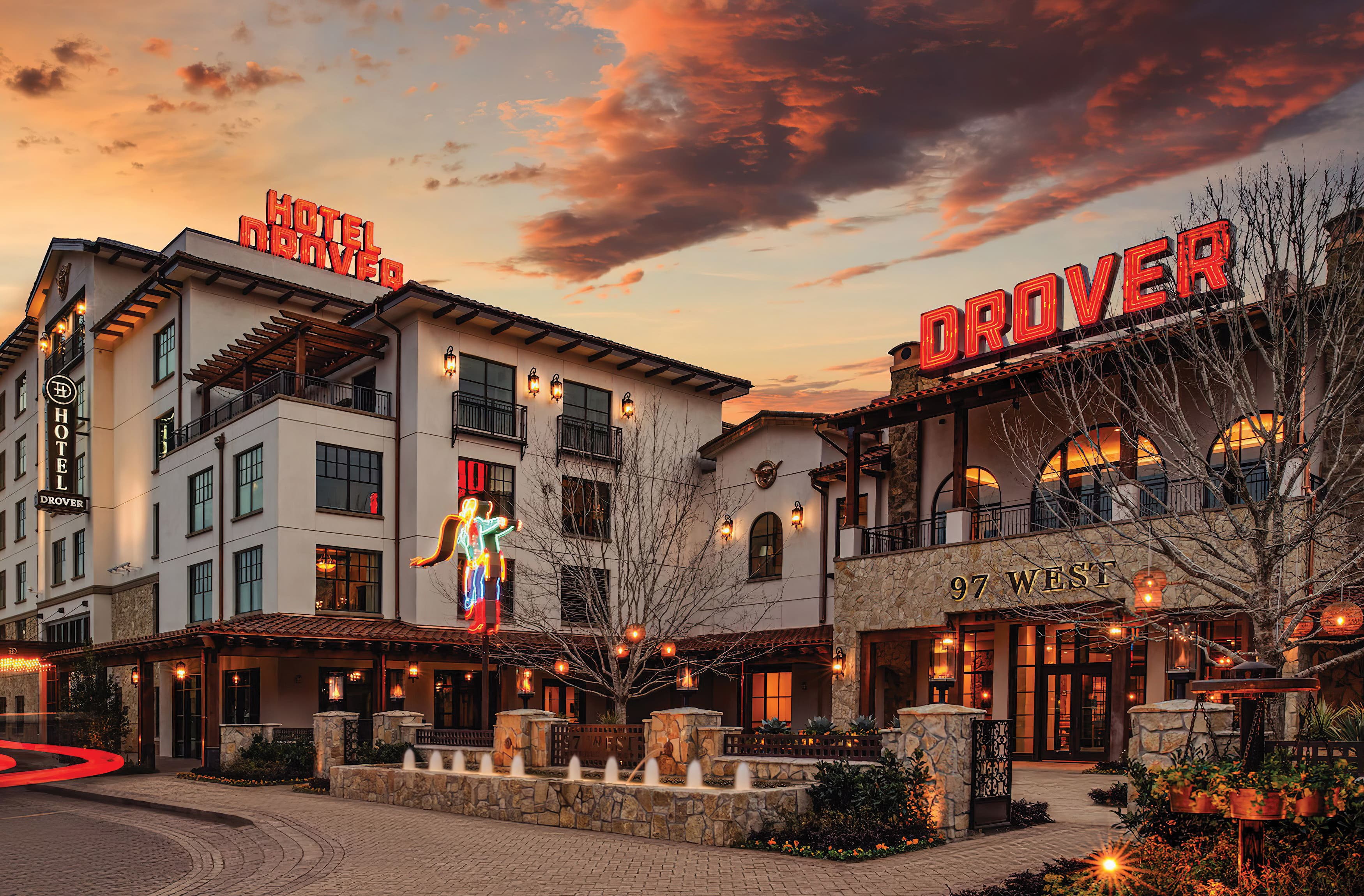 Exterior shot of The Drover Hotel in Fort Worth, Texas at sunset. Neon rooftop signage at sunset. 