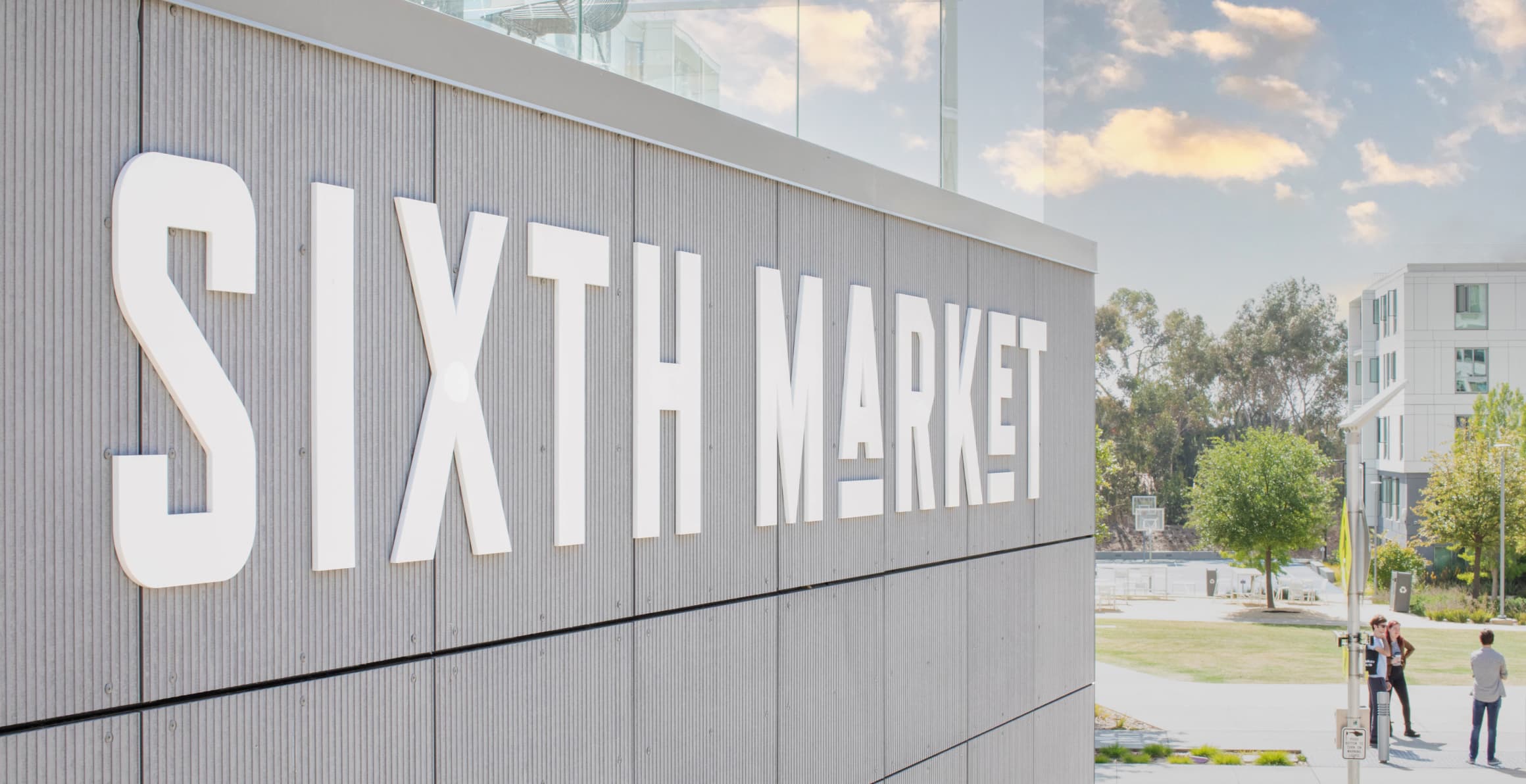 Detail of white "Sixth Market" dimensional letter project identity mounted to facade for UC San Diego Sixth Market by RSM Design in San Diego, California.